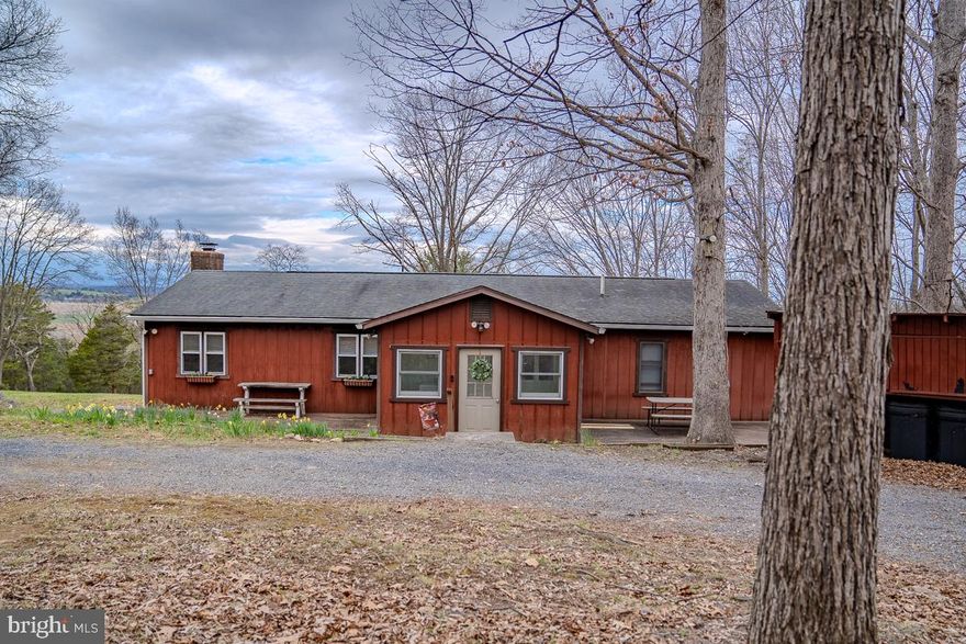 Privacy, mountain views, and nearly 10 acres — this spacious ranch checks every box. The open, single-level layout includes 3 bedrooms, 2 bathrooms, a dedicated office, and not one but two living rooms, both with custom built-in bookshelves. The family room with a wood stove— because some evenings just call for a real fire, opens up to a beautiful screened-in porch with those awesome views. The oversized owner's suite comes with an attached sitting room that's ready to become your reading nook, home gym, or that hobby room you've been promising yourself. A 2-car garage with workshop space, open shed, and circular driveway round out the package — and with 9.9 acres right outside your door, hikers and gardeners, disc golfers and bikers, and more are going to feel very much at home.