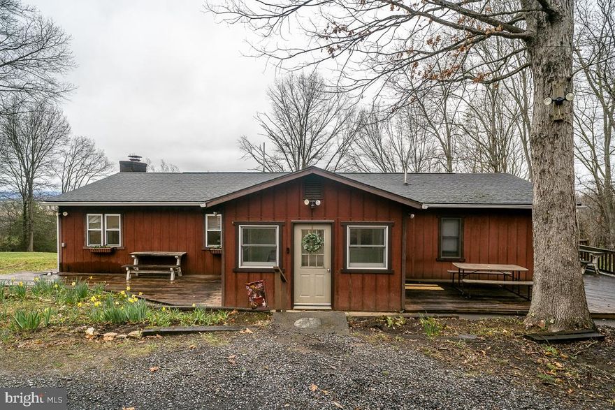 Privacy, mountain views, and nearly 10 acres — this spacious ranch checks every box. The open, single-level layout includes 3 bedrooms, 2 bathrooms, a dedicated office, and not one but two living rooms, both with custom built-in bookshelves. The family room with a wood stove— because some evenings just call for a real fire, opens up to a beautiful screened-in porch with those awesome views. The oversized owner's suite comes with an attached sitting room that's ready to become your reading nook, home gym, or that hobby room you've been promising yourself. A 2-car garage with workshop space, open shed, and circular driveway round out the package — and with 9.9 acres right outside your door, hikers and gardeners, disc golfers and bikers, and more are going to feel very much at home.