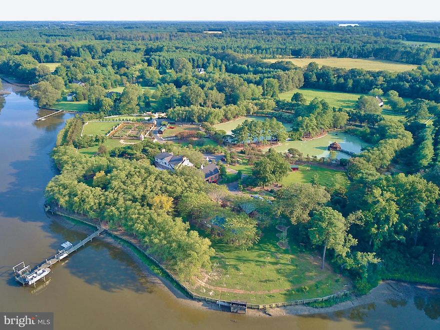 The perfect Eastern Shore escape from the rest of the world.  Situated on Glebe Creek with 12.7 acres of well-planned outdoor amenities including approximately 1,300' bulk-headed shoreline, private pier with electricity, hot & cold water, two 10,000 lb boat lifts, 2 jet ski lifts, and floating docks.    Upon arrival to the gated entry, your stresses of the day melt away as you drive across the wisteria bridge over the 2 acre pond to this stately brick home. Entering the home you will notice the extensive heart pine wood floors and custom millwork.  Expansive kitchen with wide water view perfect for large scale entertaining, a massive island, 2 G.E. Monogram refrigerators, 2 Wolf microwaves, 2 Wolf ovens, 2 Wolf warming drawers, a Wolf six-burner range/oven with French cooktop, 2 cooper farmhouse sinks and Brazilian Quartzite countertops. Five gas-controlled fireplaces can be found throughout the home. The elevator gets you from the first to the third floor with ease and is custom painted by renowned Smithsonian artist. The property boasts many places to relax including brick patios and paths, 2 Vicenza stone gazebos and 3 cast iron gazebos throughout property.  Family and friends will enjoy the many places to play including the sports court, and the 75 yard, par 3 artificial green with sand trap, the football/lacrosse field, 50'x20' heated in-ground pool with diving board, 40' x 60' playground with playhouse, Large raised-bed colonial vegetable garden with irrigation, numerous outbuildings and 3-car garage leading to a conditioned wine room.