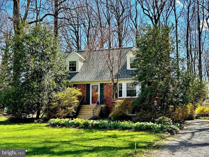 A beautifully long driveway leads you through the trees to your own sheltered cottage in the woods. Follow the sidewalk through lush perennials to the front door of this home offering so much more. Inside, you'll discover hardwood floors, a cozy wood burning fireplace, and a unique, deep-set picture window—perfect for sitting and enjoying nature through all the seasons. Toward the back of the house, there's a reading nook with built-in bookshelves. The heart of the home lies in the back, offering three-sided views of your beautiful backyard. The kitchen boasts classic white cabinets, hard surface countertops, and quality appliances. The kitchen island connects to the dining room, which provides easy access to the deck through sliding glass doors. The deck overlooks the almost-acre yard filled with azaleas, daffodils, dogwoods, forsythia, hydrangeas, hostas of all sorts, tulips and tiger lilies and rhododendrons. Additionally, you'll find a recently remodeled full bath, a bedroom, and an extra den/office/bedroom. Upstairs, there are two more bedrooms with ample storage space in multiple double closets. The primary bedroom includes a rare den/office with three-sided views of the yard. The lower level features a rec room with a custom picture window, a walkout to the backyard, another potential bedroom, and the utilities and laundry area.