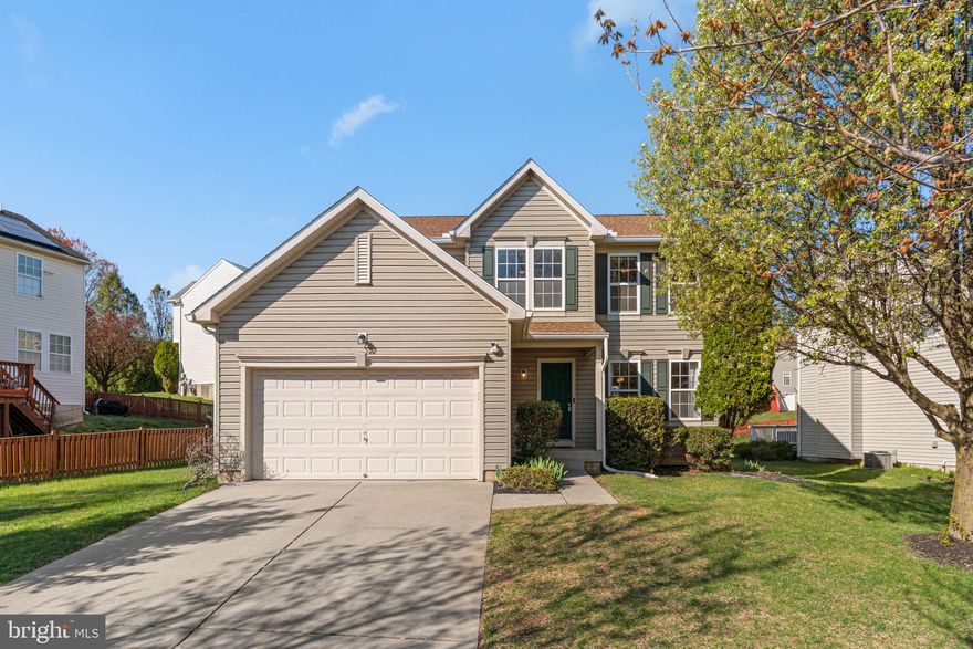 Located on a winding, tree-lined street in the Deer Run at Mayfield community, this well-maintained home offers a thoughtful layout, quality updates, and comfortable everyday living over more than 2000 finished square feet. Hardwood floors with a rich cherry finish run through the living room, dining room, and hallway, setting a warm, welcoming tone throughout the main level. The kitchen is both functional and inviting, featuring recent stainless steel appliances, natural gas cooking, cherry cabinetry, solid surface countertops, a tiled backsplash, and a center island. The adjacent breakfast area opens directly to the spacious family room, where a gas fireplace creates a natural gathering space, while sliders lead to the deck. Just off the kitchen, the first-floor laundry room adds everyday convenience with a front-load washer and dryer and built-ins for added storage. Upstairs, the well-appointed primary suite features a soaring cathedral ceiling, spacious walk-in closet, and an en-suite bath with a soaking tub, separate shower, and dual vanities. All three additional bedrooms are well-sized, each with its own walk-in closet - a rarely found bonus feature. An upper-level alcove provides flexible use as a home office, homework station, vanity area, or even a coffee bar. Thoughtful updates completed in 2025 include new sliders to the deck, a new rear door and trim in the lower level, new garage opener motor, and new carpet on the stairs, hallway, and throughout the upper level bedrooms. The home is also equipped with a new Vivint smart security system, including cameras, sensors, and a control panel. The system can be used unmonitored, or buyers may contact Vivint to activate full service for complete functionality. The expansive lower level offers high ceilings, easy access to major home systems, and walkout stairs to the lush rear yard and adjacent community open space. Whether you’re looking to create additional living areas, a home gym, or guest quarters, the layout and bathroom rough-in provides the opportunity to add both function and long-term value. The playgrounds, pavilion, and open fields of Rockdale Park are nearby, and outdoor enthusiasts will love the proximity to Patapsco Valley State Park, Diamond Ridge Family Park, and The Woodlands Golf Course. No need to take the beltway to get to Owings Mills - side roads and a short drive bring you to all of the schools, shopping, and conveniences along Reisterstown Road. Commuters will appreciate the easy access to Towson, Baltimore, Columbia, BWI, and Fort Meade. With all of the amenities that matter most, situated in a central location within a quiet neighborhood, this home is the easy choice to make your very own.