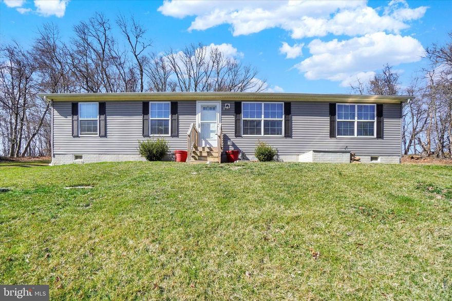 Great rural location and one level living in Red Lion school district.  Enjoy your privacy with this hilltop setting on an over 3/4 acre lot.  This 2020 model double wide manufactured home offers over 1300 square feet with 3 bedrooms, 2 full bathrooms.  The primary bedroom features a large walk-in closet and a full bath ensuite, both located on one side of the home with an additional 2 bedrooms and full bathroom on the opposite end.  An open concept floor plan for the kitchen, dining and living rooms is the focal point in the center of the home. The concrete foundation has easy access to a crawl space suitable for storage.  A 25x33 Morton Building offers opportunity for covered parking with a single, overhead door with automatic opener. There is abudant space for a workshop. Several windows allow natural daylight and a woodstove will keep you warm in the winter months while working on your projects.  Hurry! You don't want to miss this opportunity to enjoy country living!