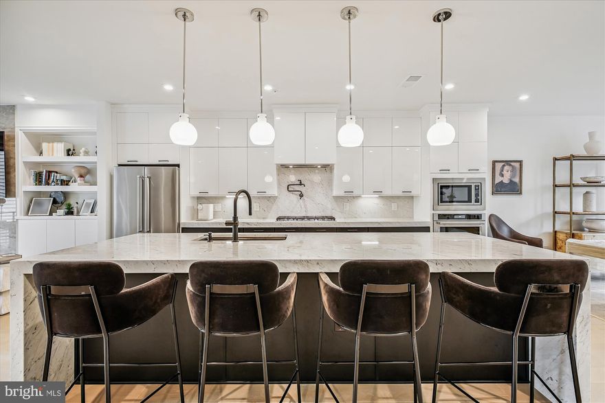 Stunning 4-Story Townhome in Union Park at McLean – Over $120K in Premium Upgrades!

Ready for immediate move in. Private elevator.  12 Minute Walk to McLean Metro Stations.

Welcome to effortless luxury, modern design, and unmatched convenience in this nearly new, 4-story townhome located in the sought-after Union Park at McLean community. With over $120,000 in high-end upgrades, this exquisite home offers a truly turnkey experience with serene green views on both sides.

Step inside to discover elegant wide-plank hardwood flooring throughout—no vinyl in sight. Take the private elevator or stairs to the expansive second-floor living area, where the open-concept layout seamlessly blends a designer kitchen, sun-filled living room, and sophisticated dining area—ideal for both everyday living and entertaining.

The culinary kitchen is a showstopper, featuring:

Calacatta Miele polished marble countertops and full-height backsplash

Premium KitchenAid appliances

Imported English wall sconces

Custom glass-door display pantry, perfect for showcasing fine dishware or collectibles

Walk-in pantry with custom shelving

Upgraded white cabinetry,

Unique pasta arm above the stove for added convenience

Upstairs, the third level is home to a luxurious primary suite with a spacious walk-in closet and a spa-inspired en-suite bathroom adorned with Calacatta Miele marble finishes, dual vanities, and a marble-tiled shower and flooring. Two additional bedrooms share a beautifully appointed full bath with marble counters and floors, and a dual-sink vanity.

The laundry room offers built-in cabinetry, marble countertops, and a real utility sink—not plastic—designed for durability and functionality.

Ascend to the fourth-floor loft and discover a spectacular rooftop terrace complete with a built-in fireplace, pre-wired TV mount, and sweeping views, ideal for entertaining, summer nights, or simply stargazing.

Additional highlights include:

Epoxy-coated garage flooring

Painted garage walls.

Added electrical outlets and lighting throughout house.

This home is the perfect blend of sophistication, practicality, and location—minutes from shopping, dining, and metro access. Don’t miss your chance to own one of the most turnkey and elevated residences in McLean.

Schedule your  showing today—your dream home awaits!