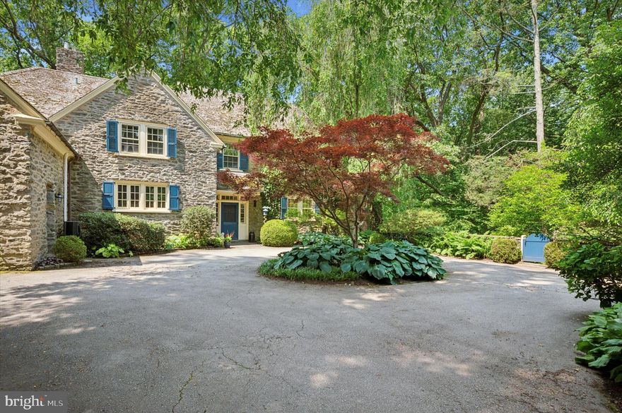 Welcome to your dream home at 7004 Wissahickon Avenue, a classic stone colonial nestled in the beautiful neighborhood of West Mount Airy, Philadelphia. This expansive 5-bedroom, 4.5-bathroom residence boasts 4,357 square feet of living space, set on a generous 1.5 acre wooded lot with a remarkable in-ground pool oasis.  

Drive down the long driveway flanked with vine-covered stone walls, leading to the circular driveway and stately front entrance.  Step inside to find a home that seamlessly marries traditional charm with modern amenities. The first floor welcomes you with a spacious living room featuring a cozy wood-burning fireplace, a formal dining room perfect for gatherings with original inlaid hardwood flooring, a sun-filled 4 season sunroom and a large chef's kitchen. The kitchen is a culinary haven with custom solid wood cabinets, top-notch appliances, a large island perfect for casual snacking, an eat-in breakfast space and a convenient bar and coffee station. For unwinding, the adjoining family room with loads of book cases and natural light, the mud room of your dreams and an adjacent powder room complete the main floor.

Up the main stairs, the primary suite offers a private retreat, with large sleeping area and updated bathroom with walk-in tile shower and separate soaking tub.  Off the primary bedroom you will find your private balcony, overlooking the beautiful gardens below.  This floor offers 3 additional bedrooms, one offering it's own private ensuite bathroom.  There are some unique features on this floor, including it's own 2nd kitchen, a bedroom with Juliet balcony, full bathroom and a rear staircase, leading back down to the mud room.  The laundry facility and flex space complete this floor.  

Head upstairs to the 3rd floor, and you will find another bedroom with En-suite bathroom and great ceiling angles.  This floor serves as both sleeping and storage space, including a cedar closet.  

Head downstairs to the partially finished basement.  There is plenty of room for your workout space and the potential "man cave"  you've been dreaming of.  The basement also contains 2 unfinished storage areas with tons of room for storing, and features an egress to the outdoors. 

Outside, an expansive mature lot has been transformed into a private sanctuary with several seating areas and an in-ground pool surrounded by lush, mature plantings—a true oasis for relaxation and entertainment.  The beautiful pool area has a flagstone patio, granite pool bottom and its own water fall.  After your dip in the pool, you and your guests can head into the private sauna outhouse.  For some exercise, you will find your own mini trail right on your property and when you need more... you can head out the private entrance to the Wissahickon Trail.

This special Mt Airy home has been updated with tons of modern amenities, including central air conditioning, an updated gourmet kitchen, three bedrooms with en-suite bathrooms and a layout perfect for todays living.  The original charm will make you feel warm inside while the numerous outdoor spaces offer a private gardeners paradise.  Don't miss the chance to make this exceptional property your own!