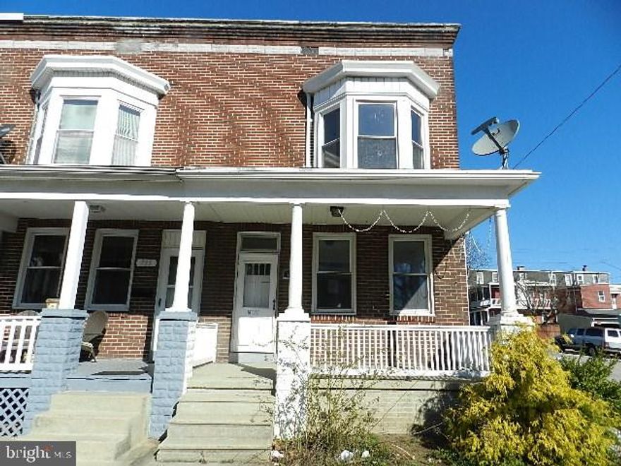 Semi-detached brick townhouse located on a corner lot features three bedrooms and one full bath. Covered front and back porch with a balcony on the 2nd floor. Large 2 car detached carport. Big double living room with laminate flooring, separate dining room, full concrete basement with laundry hookup. Fenced back yard. Unknown roof material. Property is being sold in AS IS condition. Seller will make no repairs.