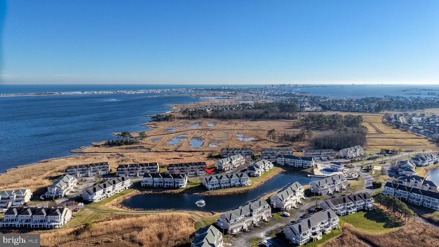 Discover a rare gem within the prestigious Bayville Shores community in this stunning 3-bedroom, 3.5-bath end-unit townhome, distinguished by its prime positioning that offers breathtaking, direct water views of the Assawoman Bay—a coveted feature unavailable in many other units. Boasting the desirable "Court End" floorplan, this 2,750 sq. ft. residence offers an abundance of natural light through extra windows found only in end units, illuminating rich hickory hardwood flooring and designer vignettes throughout. Designed for multi-generational comfort or hosting guests, the layout features rare dual primary suites—one conveniently located on the first floor and a second private retreat on the third floor.

The heart of the home is the main living level, where a gourmet kitchen flows seamlessly into the dining and living areas, anchored by a cozy fireplace. Step into the bright Sun/Florida room or extend your entertaining outdoors onto the massive wrap-around TimberTech sun deck, offering serene pond and water views. The ground level adds versatility with a wrap-around lanai, perfect for relaxing in the shade after a day at the beach. Additional highlights include a spacious third-floor guest ensuite, a one-car attached garage, and ample storage for beach gear.

Residents of Bayville Shores enjoy an amenity-rich lifestyle with access to a community pool, fitness center, boat ramp, tennis/pickleball courts, and tot lots, all while having exterior maintenance, lawn care, and trash removal covered by the HOA. Located just minutes from the pristine beaches of Fenwick Island and Ocean City, and a short drive to the Freeman Arts Pavilion and Route 54 dining, this home is the perfect year-round sanctuary, vacation getaway, or lucrative rental opportunity. Schedule your private tour today!