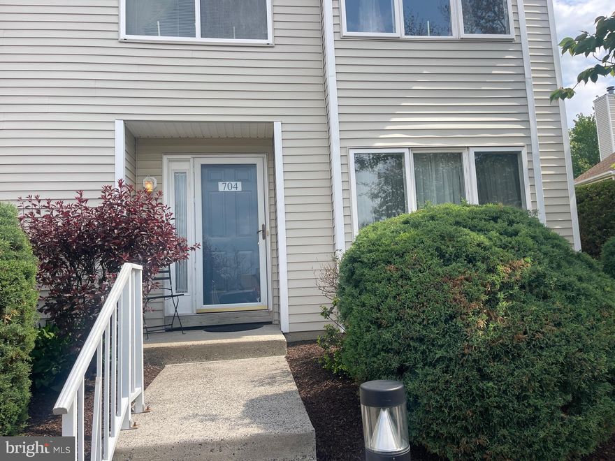 Welcome home to this spacious and well-maintained end-unit townhome, ideally situated in one of the most desirable and convenient locations within Montgomery Place. Just steps from the community pool and clubhouse and within walking distance to shopping and everyday conveniences. Upon entering, beautiful wood floors guide you into the inviting living room, highlighted by a handsome fireplace with a marble surround and classic wood mantel — an ideal focal point for both relaxing and entertaining. The dining area features sliding glass doors that open to the patio allowing the natural light to fill the room and creating an easy flow for indoor-outdoor living. Adjacent to the dining space is a charming eat-in kitchen, while the nearby laundry room offers added convenience along with ample space for additional storage.  The second level offers a welcoming landing that leads to a spacious primary suite with a full bath, two additional generously sized bedrooms, and a hall bath. Combining space, location, and value, this home presents a wonderful opportunity to enjoy low-maintenance living in a sought-after community.