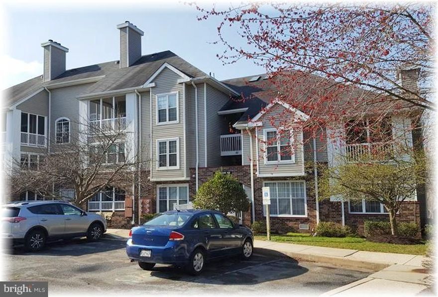 This 2nd fl. unit w/ a ground level entry provides a no steps entry, plus an elevated, panoramic view of the rear woods from your climate-controlled sunroom.  It features 2 spacious BRs, 2 full baths, updated carpeting, fresh paint throughout, vinyl tilt-in windows a fireplace w/ a pellet stove and a bright, open floor plan. Enjoy the community pool, fitness center & pond. Sq. footage is estimated