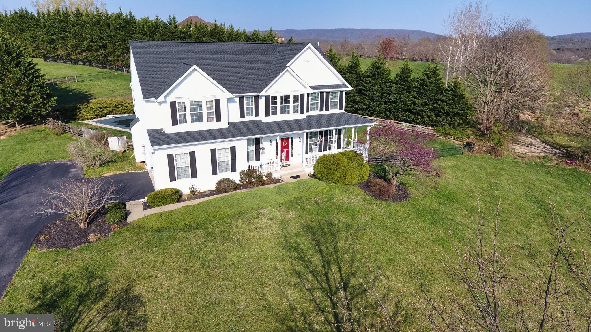 Tour this beautiful Colonial resting on an acre of rural land with beautiful Mountain Views! This home, located on a quiet cul-de-sac, boasts 3600+ Sq Ft of living space on 3 Finished Levels. The main level features a 2 story Foyer with hardwood flooring, Formal Living and Dining Rooms, Family Room with cozy efficient Pellet Stove, Gourmet Kitchen with Stainless Appliances, island, built-in microwave, upgraded counter tops, gas range, and breakfast room. Upper level houses 4 Bedrooms including the Primary Owner's Suite with Cathedral Ceiling, walk-in closets, and attached private luxury bath with soaking tub and separate shower. Fully finished lower level has a spacious Recreation Room, additional full bath, and potential 5th Bedroom perfect for out of town guests visiting! 2 car side load garage, and plenty of outdoor entertaining space including the spacious front porch, rear deck, patio, and personal in-ground swimming pool perfect for the upcoming summer months! Close to Rt 340 for easy commuting and minutes to neighboring towns such as Charles Town, Historic Harpers Ferry, and Shepherdstown! A MUST SEE!