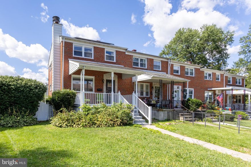 Beautifully  updated end of group townhouse with rear sun porch and rear parking pad. Fully finished basement. 4 bedroom, 2 full bath. Updated gem with custom fireplace.