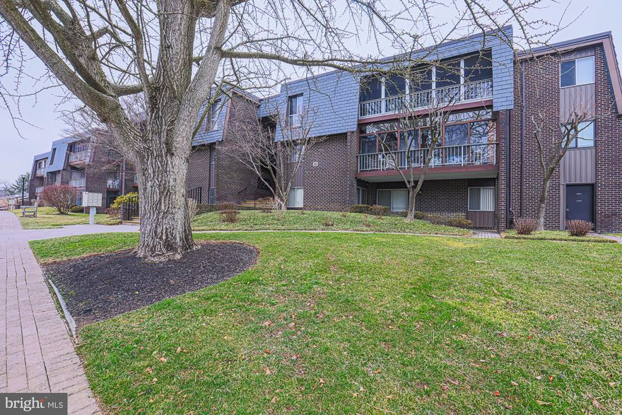 **SUBSTANTIAL PRICE DROP!!** Unique first floor unit offers option for 'no stairs entry' via sidewalk from parking area directly to ground level covered porch with two sliding doors.  Bathed in natural light, this modern, open concept  marries defined living space with seamless flow.  Features include brand new furnace, wood parquet flooring, 22 foot covered porch for outside living, 13 x 6 walk-in closet complete with built-ins, eat in kitchen, laundry, alarm system.  Condo fee includes  water, sewer, gas heat,  trash pick up outside your door,  snow removal, storage bin.  Community amenities feature beautifully landscaped grounds, gorgeous pool, clubhouse, security gate, walkways, street lighting, abundant parking.   Serenity abounds in this ideal location and offers easy access to local amenities and commuter routes.  This building has a new roof with a $79,00 assessment, included in monthly condo fee through December 2025.  Service/comfort animals only.  Home sold AS IS.  Some photos virtually staged with furnishings to show versatility of space.