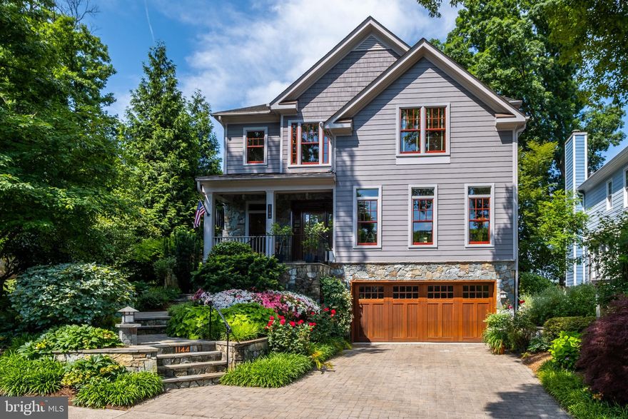 Offer deadline 5 pm on Monday, June 19.  Nestled in the heart of Arlington on a lovely wide street, this remarkable 5-bedroom/5.5-bathroom property offers an unparalleled combination of luxury, distinctive taste, and timeless elegance. No detail was overlooked in this Arts & Crafts-style home, with every design choice sourced by the highest quality artisans and makers. This home unfolds like an architectural showcase, while remaining a highly livable oasis.
 
The bright and inviting open floor plan seamlessly blends modern design with warm, refined accents like the custom mahogany front door (with handmade stained glass!) and garage door, stone accents and rich color choices. The spacious living area, including an irresistible main floor library with built-in bookshelves, features large windows - all the home's windows are Pella and replaced in 2020 - allowing abundant natural light to complement the hardwood floors and natural wood throughout. The lighting choices - all in Arts & Craft style - complete the intentional, distinctive ambiance throughout the entire home.
 
The chef's kitchen, redone in 2020, is a true masterpiece, boasting top-of-the-line stainless steel appliances: 36-inch Wolf gas range, dual Wolf wall ovens, Sub-Zero refrigerator, Cove dishwasher and Sub-Zero under counter beverage center. The backsplash is its own showcase, featuring hand-painted Motawi decorative tile designed by celebrated mid-century style wildlife artist Charley Harper. The absolute black granite countertops set off the sleek custom cherry cabinets, with a large island for additional cooking space and ample storage space. The butler’s pantry can be used as a dedicated beverage station, complete with a wine fridge.
 
The main level includes a spacious yet cozy great room with a gas fireplace set off by a gorgeous Motawi custom tile surround and mahogany wood mantle. The back doors lead out to a perfect screened in porch featuring coveted and durable Brazilian Ipe wood flooring. The yard - professionally done by celebrated Arlington landscape designers Concepts and Contours and featured as part of the Annual Tuckahoe Home and Garden Tour in 2013, is a true gem. Created with intention and incredible attention to detail, the beautifully and lushly landscaped yard has an expansive stone patio and an outdoor kitchen surrounded by stone. There is no rivaling the mature, well-tended landscaping - this yard has been loved and nurtured for many years, and it shows. The front yard - just as stunning as the back - has a custom mahogany trellis and Arts & Craft style door leading to the backyard. 
 
The upper level of the home, with a wide staircase, features a primary suite with two walk-in closets with custom organization and storage, and a luxurious ensuite bathroom with a tiled shower, soaking tub, and cherry cabinets. Three additional bedrooms upstairs, each with its own ensuite full bathroom, provide ample space for family, guests or office space.
 
A fifth bedroom in the spacious basement has been converted to a wine connoisseur’s dream, with a full-size wine refrigerator, second stainless steel full-size refrigerator, built-in cabinetry and wine storage, with an ensuite full bathroom. The rest of the basement, with easy access to the backyard, is perfect for an office, playroom or media room. The two-car garage completes this endlessly usable lower level space. 
 
New heat pumps, water heater and a whole house humidifier were installed in 2018. There is a sump pump and back-up battery. The convenient upstairs laundry has an LG washer and dryer that are approx 5 years old.
 
Located in North Arlington's highly sought after Lacey Forest - with sprawling Lacey Woods park mere blocks away, this  home has access to the best of Arlington: both Ballston and East Falls Church Metro stations, 66, the Custis Trail, proximity to VHC and many beloved local restaurants.   McKinley Elementary, Swanson Middle and Washington-Liberty High School district.