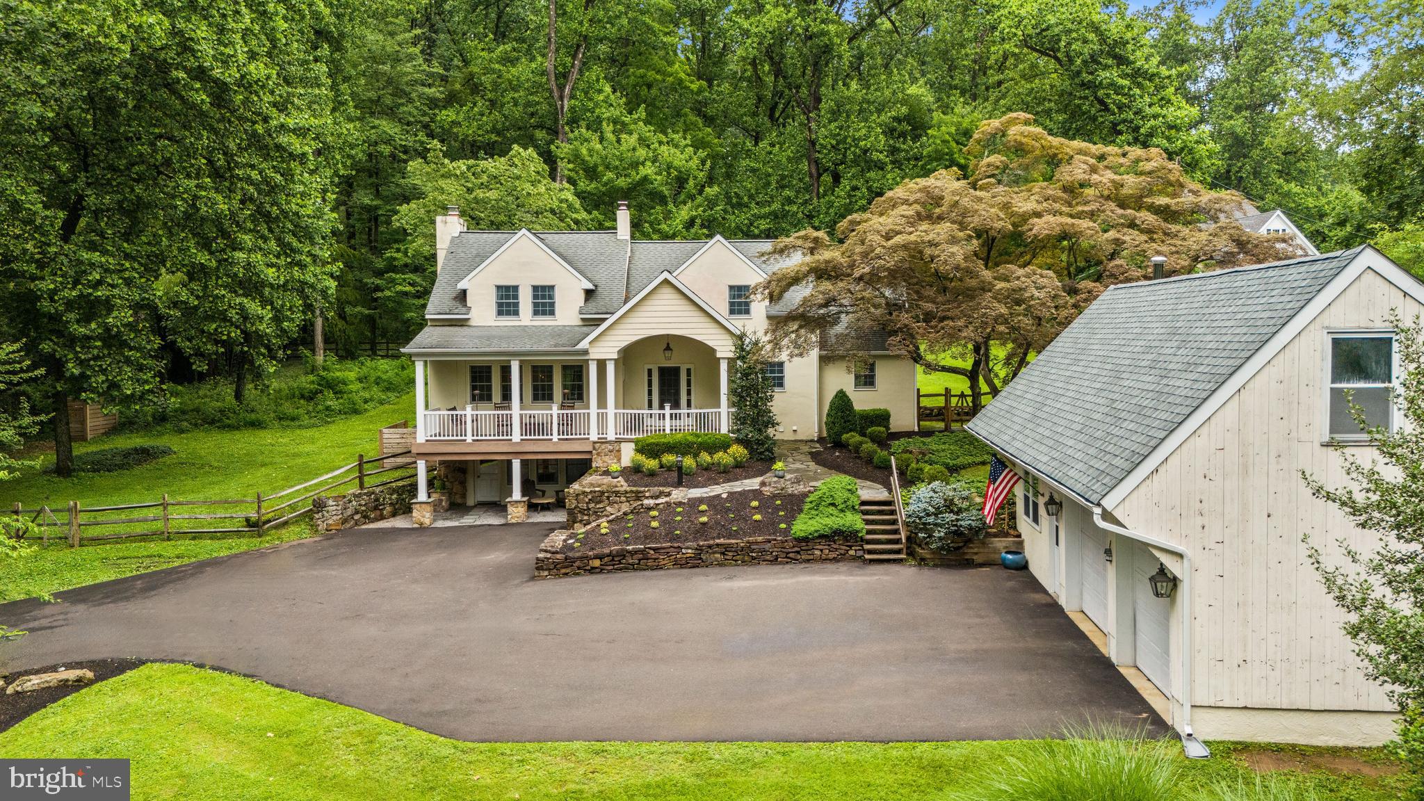 Tucked away on 3 quiet acres in Solebury and located just minutes from Stockton, New Hope, and Peddler’s Village, this charming home offers the perfect blend of privacy, personality, and proximity.
At the top of a long, meandering drive, you are greeted by mature trees, stone walls, and an enchanting front porch. Surrounded by nature at every bend, you’ll awaken to the delights of bird song and relax to the sound of tree frogs chirping at sunset.
The character continues as you enter the home. Hardwood floors carry you through each room, complimented by an abundance of windows, allowing the outside, in. A large, open kitchen connects to a dining area, complete with an authentic mid century modern wood stove, offering the ideal space for gathering and entertaining. While the adjacent living room with floating staircase and built-in fireplace provide the perfect balance of spaciousness and cozy.
Continue upstairs to find the primary and guest bedrooms. The primary is fit with a walk-in closet, built in bookshelves, and a sweeping vista of your fully wooded backyard. Additionally, the upstairs full bath provides both a standing shower and tub. Downstairs you’ll find a fully finished garden level. Perfect for guests, this entry level floor boasts a full bedroom, walk-in closet, and full bathroom. An unexpected delight exists just around the corner as you enter a newly finished wine cellar, perfect for playing cards or sipping special libations.
Stepping onto the property, you will also take note of multiple other outbuildings - a 2 car garage, complete with a workshop space, a large shed, and an additional fully refurbished ancillary shed towards the woods. The backyard consists of two fully fenced paddocks, to be used for leisure activities or even a furry friend.
This home is an exclusive delight - seclusion, comfort, and character, all wrapped up in one of the most sought after school districts in the state. A rare blend of charm, functionality, and tranquility—this home is a must-see.
