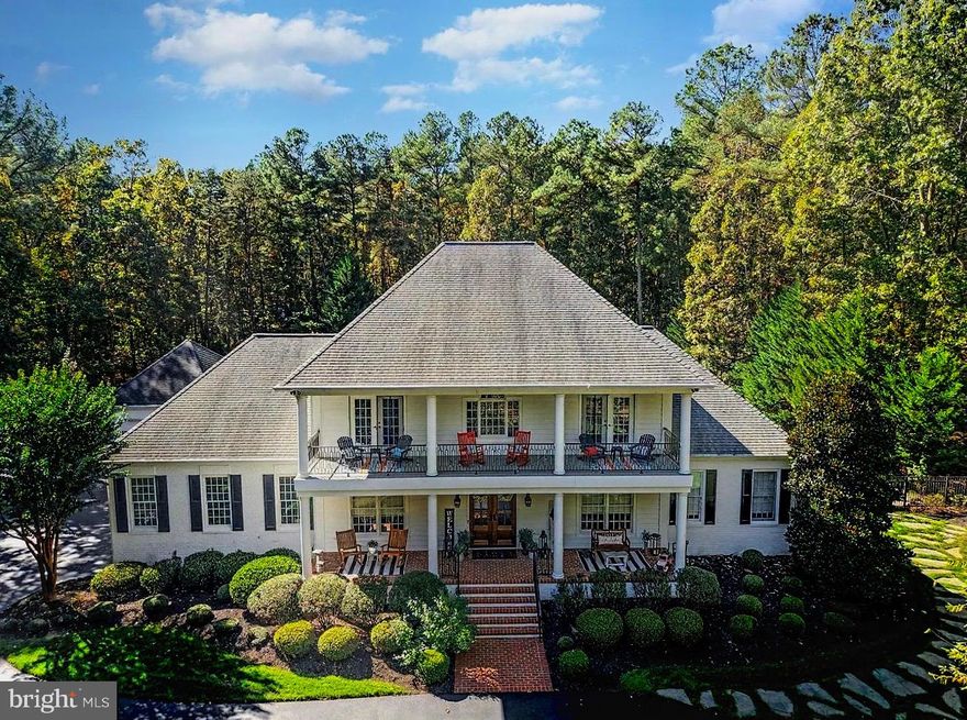 Presenting an exclusive Fawn Lake estate, an architectural masterpiece on over 3 wooded acres, this is a private resort-style retreat complete with a custom saltwater swimming pool and koi pond. Situated in the gated community of Fawn Lake, this executive property is designed for both grand entertaining and comfortable daily living. From the stately circular driveway framed by flowering trees to the striking façade with double mahogany doors and stacked porches showcasing custom designed wrought-iron railings, this home makes a lasting first impression.
Inside, a dramatic two-story foyer with sweeping staircase and architectural detailing sets the tone for timeless sophistication. The formal dining room features exquisite trimwork and walls of Anderson windows ideal for hosting gatherings, while the living room showcases a fireplace and panoramic views of the landscaped gardens and pool. The recently remodeled gourmet kitchen includes custom soft-close cabinetry, quartzite counters, marble backsplash, designer lighting, touchless fixtures, and top-tier Wolf appliances throughout. A large center island with prep sink, wine fridge, and ice maker connects seamlessly to the bright breakfast area and family room, which is highlighted by soaring windows and a dramatic stone fireplace. The main-level owner’s suite offers a sitting area, dual walk-in closets, and a recently meticulously renovated spa-inspired bath with soaking tub, oversized shower, and private access to the rear veranda.
Upstairs, two expansive bedroom suites with en-suite baths and French doors to the front porch, plus a third en-suite bedroom with walk-in closet, provide ample living space. The lower level has been recently remodeled with luxury vinyl plank flooring and a custom wet bar by Fraser Wood Elements. This open-concept area includes a recreation room, game room or optional bedroom, den, full bath, and abundant storage—ideal for entertaining.
The backyard offers a private resort designed for year-round enjoyment, featuring a heated saltwater pool with spa designed by Sylvan Pools, flagstone terraces, outdoor dining patios among gardens and stone courtyards, and a custom koi pond with waterfall and more than 30 koi. Professional landscaping includes ornamental plants, flowering trees, raised vegetable beds, and custom exterior lighting with four low-voltage zones. The estate includes a three-car attached garage plus a separate detached 30-foot garage and pool house with full bath. Sprinklers and Pool are supported by a 150-foot deep well with high-pressure pump and 22 irrigation zones with more than 50 sprinkler heads and 8 soaker beds.
Recent updates ensure modern comfort and efficiency, including fully upgraded dual-zone HVAC systems with new attic and basement furnaces, a brand new 2024 Generac whole-home generator with Bluetooth and WiFi, resurfaced garage flooring with a 9K lbs. lift, updated pool and koi pond systems, a Tesla 200-amp home charging station in the detached garage, and enhanced landscaping with new trees, shrubs, lighting, and a backyard firepit.
A partial golf membership to Fawn Lake Country Club conveys with the property, providing access to a private lake with marina and beach, championship golf course, tennis and pickleball courts, walking trails, fitness center, sports fields, dog park, restaurants, and a vibrant social club—all set near Fredericksburg, wineries, farm markets, and award-winning breweries.