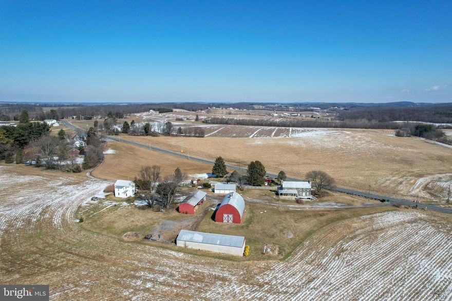 Rare opportunity to own a 130-acre farm in Ag Preservation featuring approximately 112 acres of rich cropland and 12.9 acres of scenic woodland with a stream. The property includes two homes and multiple outbuildings, ideal for farming, investment, or peaceful country living. The single-family home offers an open kitchen and dining area, living room with exposed ceiling beams, laundry room and mud room on the main level, and three bedrooms with one full bath upstairs. Additional features include replacement siding and windows, covered front porch, rear concrete patio, and a new hot water heater (2023). The stone duplex at 3070 Marston Rd provides additional living space or income potential. Unit B includes a living/dining room combo, kitchen, and full bath on the main level, with two bedrooms upstairs plus a third room currently used as a walk-in closet. Updates include plumbing, electric, windows, indoor stairway and risers (2019), LVP and tile flooring, hot water heater (2020), and chlorine water treatment system (2024). Outbuildings include a 36x56 barn, 24x64 machine shed, 6-bay equipment building, and 4-car detached garage with electric. Metal roofing on the homes and outbuildings has been recoated, the barn has been painted, and all 10 garage doors have been replaced. Property is served by two septic systems and one well. A solid agricultural property with established infrastructure and multiple possibilities. Drone footage: https://youtu.be/9RDzccchIyE?si=blPo0hMgcWWKcKFp