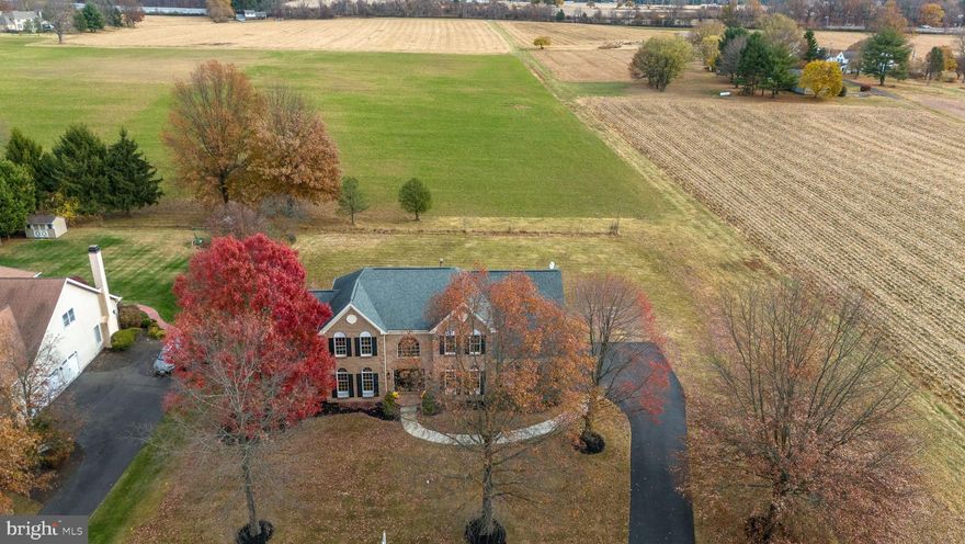 Welcome to 1100 Surrey Lane, a 5-bedroom, 3.5-bath Colonial in the prestigious Bridle Estates community of Yardley, PA. Set on a tranquil cul-de-sac backing to open farmland, this home with over 4700 finished sq ft of living space offers a perfect blend of elegance and functionality.
The grand two-story foyer features travertine marble floors and a curved staircase, leading to formal living and dining rooms. The kitchen includes a walk-in pantry, island, and breakfast area with French doors opening to a pressed concrete patio. Adjacent, the family room boasts cathedral ceilings and a gas fireplace. A private office with built-ins, laundry room, powder room, and 3-car garage with Tesla charger complete the main floor.
Upstairs, the primary suite offers cathedral ceilings, dual walk-through closets, and a spa-like bath with soaking tub and walk-in shower. A princess suite, three additional bedrooms, and a hall bath complete the level, along with walk-up attic access.
The finished basement features a wet bar, expansive rec space, and two bonus rooms for guests, a gym, or an office.
Conveniently located near I-295, shopping, dining, and top-rated schools. Don't miss this opportunity—schedule your showing today!