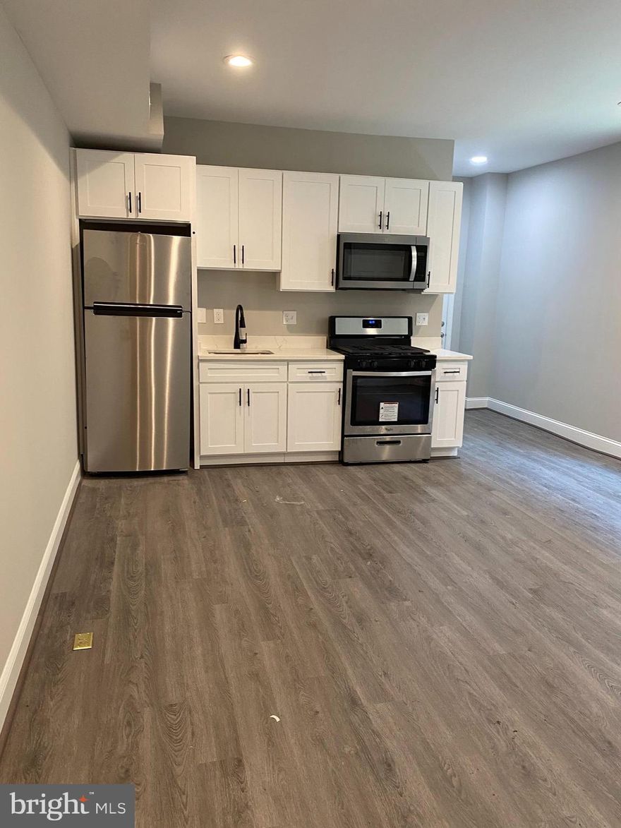 Terrific renovated main level apartment in Woodberry. Just north of the Baltimore Zoo you'll love the private feel of the tree lined street when you come home. This apartment feels huge with plenty of windows and natural light pouring in you'll never want to leave. Both bedrooms are on opposite sides of the apartment with a great room feel in the center of the home tying in the kitchen space. All new stainless steel appliances and mechanical systems mean you should have lower energy bills.  There is a rear fenced in yard perfect for gardening or outdoor activities.  The washer and dryer are located in the basement level and there is tons of storage for all your belongings. Don't miss out on this excellent opportunity.