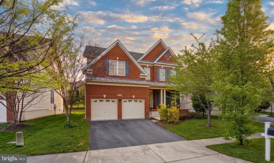 Located on one of the final streets built in South Riding by Toll Brothers, this home features the rarely available Woodstock Federal model—a layout known for its larger living room, more open foyer, and overall better flow compared to standard designs. It also includes the optional 5th bedroom on the upper level, adding flexibility that’s increasingly hard to find.
Over time, the home has been thoughtfully improved with more than $250,000 in builder and aftermarket upgrades. Hardwood flooring runs throughout the main level, while the upper level has been updated with newer LVP. Fresh paint and over 5,200 square feet of well-utilized space give the home a clean, cohesive feel throughout.
The main level is designed to flow naturally, with the kitchen opening directly into the family room to create a comfortable, connected living space. Granite countertops, maple cabinetry, stainless steel appliances, and a center island anchor the space, making it both functional and easy to live in day to day. The main level also opens to a large deck spanning over 575 square feet, complete with privacy screens.
A light-filled sunroom extends off the main living area, adding additional square footage and creating a natural transition between indoor and outdoor spaces. It’s a versatile area that works equally well as a sitting room, casual dining space, or secondary lounge. The lower level benefits from an extension that enhances the overall footprint, while the expanded garage provides added width and storage capacity—an often overlooked but highly practical upgrade.
Upstairs, the primary suite is spacious and private, with walk-in closets and a spa-style bath. The additional bedrooms are well-sized, and the extra fifth bedroom on this level offers options for guests, workspace, or long-term flexibility.
The lower level is fully finished and designed with purpose. A permitted kitchen, large recreation area, theater room, bedroom with two closets, and full bath create a setup that works well for extended stays or separate living space when needed. The home backs to a walking trail with no homes directly in front, offering a greater sense of privacy.
In addition, multiple appliances will convey with the home, including the main kitchen refrigerator, microwave, and cooking range, along with washer and dryer units on both the main level and basement. Two additional refrigerators—located in the basement kitchen and garage—will also convey.
Living in South Riding also means access to a wide range of amenities, including multiple pools with a splash park, sports courts, pickleball, trails, clubhouse, and more. The home is just minutes from shopping, dining, and walking distance to Dulles South Recreation and Community Center, with convenient access to Route 50, I-66, Route 28, Metro, and Washington Dulles International Airport.