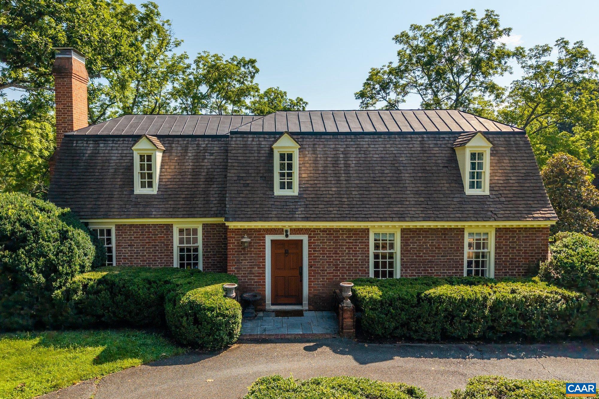 Tucked away on 11.5 peaceful acres, this French-style estate blends timeless European design with modern comforts. Originally built in 1964 using imported materials, the home has been thoughtfully renovated and expanded. It features 4 bedrooms, 3.5 baths, and a dramatic hallway with marble and wood inlay floors, custom built-ins, and a wall of windows. The spacious European-style kitchen includes a fireplace, window seat, and large island?ideal for everyday living and entertaining. A formal dining room and sunlit breakfast room add character and charm. Living and family rooms boast floor-to-ceiling windows framing pastoral and lake views. The fourth bedroom serves well as a guest suite or office with its own bath and entrance. Outdoor spaces include a covered porch, bluestone patio, and a pristine lap pool. A three-stall barn makes it equestrian-ready. Private yet close to town, this refined retreat offers serene living in a storybook setting.