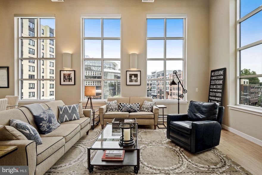 Light filled, stunning penthouse with over 1,500 square feet! Welcome to this gorgeous two bedroom, two bathroom with den condo in the heart of Silver Spring.   Floor to ceiling windows flood this two story living/dining room with light and views from every direction, while custom motorized window treatments allow privacy. The updated flooring and vaulted ceilings make this a one-of-a-kind home. The open, bright white kitchen with island is perfect for the most discerning chef, and the perfect spot to prepare or host any occasion. Off the kitchen is the large second bedroom separated by a jack and jill bath to the spacious den. Custom bookshelves in the den surprisingly turn into a Murphy bed; the perfect place for working from home or that extra little bit of living space. A patio perfect for dining al fresco finishes off this level.   Upstairs buyers will find a vaulted den and beautiful master suite. Open to below and customized with a retractable wall the master can be flooded with light or cozy and dark with the flip of a button. The updated owner's bath, custom closets, new wood floors on the main level and new HVAC  are the perfect finishing touches to this stunning, turn key home! And to top it off, this pet-friendly building conveys with one parking space.  Located just blocks from the metro, grocery, coffee shops, Flimore, library and new PURPLE Line, this is the quintessential property for urban living.