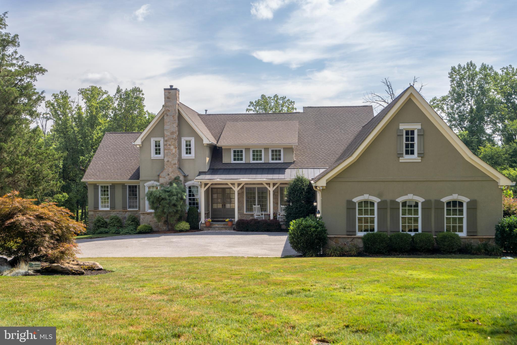 Welcome to 1307 Dulaney Valley Rd, a stunning French Country-inspired residence, custom-built in 2007 for its current owners. This home epitomizes casual elegance with its thoughtfully designed open floor plan, offering approximately 6,000 square feet of luxurious living space. Boasting 10-foot ceilings, intricate millwork, graceful archways, hardwood floors, and top-of-the-line appliances, this residence promises an exceptional living experience.
Set on 1.9 meticulously landscaped acres in the sought-after Hampton community, this property ensures privacy with its secluded pipeline driveway, while remaining conveniently close to the beltway.
The charming curb appeal is immediately evident as you approach the home via a circular driveway. A welcoming covered porch leads you through double doors into a spacious foyer, which opens to an elegant dining room and a handsome library with a mantled gas fireplace, accessible through pocket doors. The heart of the home, the expansive family room, is bathed in natural light and features a stone fireplace flanked by large windows with transoms. The gourmet kitchen, a chef’s delight, includes a large island, Wolf cooktop, beamed ceilings, and a sunlit breakfast area. Enjoy your morning coffee in the cozy screened porch overlooking the beautifully landscaped, fully fenced rear yard.
The main floor also includes a luxurious primary bedroom suite with a spa-like bath featuring a soaking tub and a spacious, dedicated dressing room. Additional conveniences on this level include a powder room and a dedicated laundry room.
Upstairs, you’ll find an optional second primary suite with a private bath, a loft area, and two additional bedrooms that share a hall bath. The lower level is designed for relaxation and entertainment, featuring a rec room with a full wet bar, an exercise room, and a fourth full bath. There’s also a workspace and a utility room offering ample storage space. Available for showings starting at the Open House, Wednesday, August 7th from 1-3pm