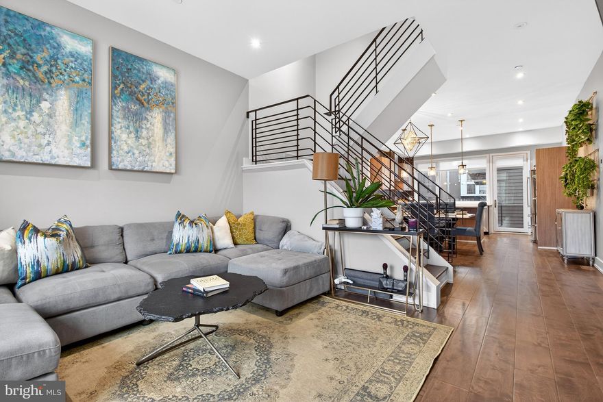 Welcome to 607 N 6th Street, a 4-bedroom, 2 full bath, and 2 half bath home located in the heart of Northern Liberties, Philadelphia. As you enter the home, the first bedroom is conveniently located to the left, offering flexibility for guests, a home office, or additional living space. Continuing past the foyer, you’ll find stairs leading up to the main living level and down to the finished basement. Just beyond the staircase is a convenient powder room along with access to the one-car garage. Heading up to the main living level, the living room sits to the right of the staircase and features luxury wood plank flooring that runs throughout the entire home. To the left is the dining room, highlighted by a chandelier and offering a comfortable space for entertaining. Just beyond the dining room is the chef's kitchen, which features wooden cabinetry, stainless Bosch steel appliances, and a peninsula with seating. A door from the kitchen provides direct access to the back balcony, creating an easy indoor-outdoor connection. The third level offers two additional bedrooms. One bedroom features access to a private balcony. Also on this level is a convenient laundry closet with a LG washer and dryer and a full bathroom complete with luxury Porcelanosa tile, a double sink vanity, and a walk-in shower. The entire fourth level is dedicated to the primary suite. The spacious primary bedroom is complemented by a large walk-in closet and a private bathroom featuring Porcelanosa tile flooring, a soaking tub, and a walk-in shower with a built-in bench. Near the staircase leading to the roof deck is an additional powder room, providing convenience when entertaining upstairs. The dual-sided roof deck spans the full length of the home and offers the perfect outdoor space for relaxing or entertaining while enjoying city views. The finished lower level provides additional flexible living space that can easily serve as a home gym, media room, or recreation area, along with a separate storage room. Conveniently located near local grocery stores, restaurants, shopping, and entertainment, this home offers easy access to everything Northern Liberties has to offer. Don’t miss your opportunity to make 607 N 6th Street your new home.