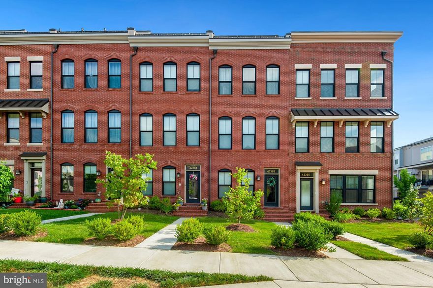 Stunning Townhouse in the desired community of Brambleton! This beautiful home has 4 bedrooms, 4.5 baths, 1 car garage, 4th floor loft, and a rooftop terrace. Gorgeous hardwood floors upon entry, which continue throughout the main level. Gourmet kitchen with upgraded cabinetry, granite countertops, backsplash, stainless steel appliances, extra large sink, range vent, center island, leading to the balcony. Open floorplan combines dining/living and features a custom brick focus wall and cozy fireplace. Modern light fixtures. All bathrooms showcase classic floor, shower tiles and vanities.  The primary bath has a frameless shower. Washer and dryer are conveniently located on the 3rd level. The top level includes a 4th bedroom and upgraded bath, along with an open loft and rooftop terrace.  Enjoy fantastic amenities in Brambleton (pools, walking/jogging trails, tennis courts, volleyball court, basketball court, tot lots/playgrounds) and a great location - short walk to the Town Center with multiple restaurants, shopping, and a movie theater.  Minutes to Loudoun Station, Silver Line Metro, Dulles Tollroad, Loudoun County Parkway, and Dulles Airport.