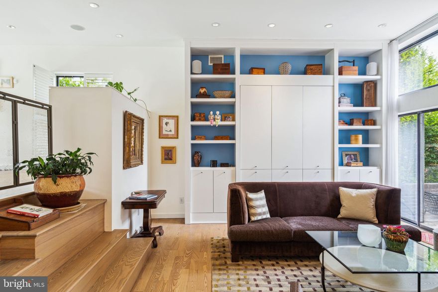 Welcome to 248 Locust, a spectacular 24’ wide, 3Bed, 3Bath corner townhome in Society Hill with 2-Car Parking, stunning loft-like proportions and abundant natural light. Designed by renowned modernist architect Louis Sauer in 1970 and thoughtfully renovated in 2016, this home offers a perfect blend of timeless design and modern comforts.

Enter into the sprawling open-plan living space with dramatic 11’ ceilings and sumptuous 1.25” thick white oak floors throughout. The expansive great room  features a wall of custom built-ins and a wood burning fireplace with an elegant limestone surround flanked by a pair of floor-to-ceiling windows. The spacious dining room is illuminated by a large picture window overlooking the courtyard. The well-appointed chef’s kitchen boasts gleaming Calcutta Gold marble countertops, a Joanne Hudson tile backsplash and top-of-the-line appliances including a SubZero refrigerator, Viking cooktop and oven, and Miele dishwasher. Island seating offers the ideal perch for enjoying a glass of wine with the chef or your morning espresso. 

The upper floor offers 3 spacious bedrooms and 2 full baths. The primary suite is a peaceful oasis with tree top views and ample closet space for complete organization. The serene primary bathroom has a walk-in shower, dual-sink vanity, Joanne Hudson tiles, radiant floor pad heating and adjoins a luxurious walk-in closet. The additional 2 bedrooms offer lovely nighttime views of St. Peter’s spire.

The recently renovated lower level offers a full bath, custom built-ins, a mudroom with radiant heat flooring, and floor to ceiling glass sliders leading out to the landscaped garden patio. 

Centrally Located on a quiet tree-lined street in the McCall School catchment, you'll find yourself just steps away from Philadelphia's most historic sites and museums, Head House Square, Spruce Street Harbor Park, PFS Movie Theater, and a broad range of restaurants, and public transportation. Complete with 2 car gated parking this home is an urban dream!