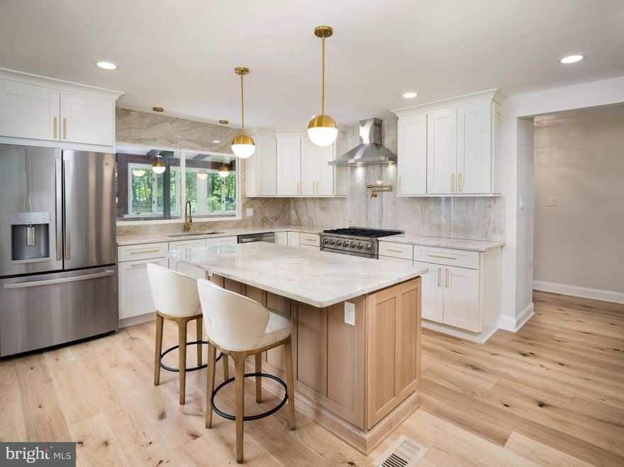 Welcome to 581 Woodland Drive, a beautifully renovated 4-bedroom, 2.5-bath colonial nestled on a full acre in the sought-after Upper Merion Area School District. This forever home seamlessly blends timeless architecture with contemporary finishes, offering over 2,675 square feet of refined living space—plus an additional 750 square feet in the fully finished basement. Set on a quiet cul-de-sac, the property is surrounded by tall, mature trees, with a private drive leading to a side-entry 2-car garage. The home's layout supports today’s lifestyle, with flexible spaces and upscale details throughout. Inside, the bright and spacious living room welcomes you with custom built-in shelving and a gas fireplace. Across the entryway, the elegant formal dining room offers an ideal setting for hosting family and friends. At the heart of the home, a chef’s dream kitchen features custom antique white shaker and white oak cabinetry, luxurious Taj Mahal Quartzite countertops with backsplash, and a central island perfect for gathering. Just beyond the kitchen, a sunroom features a charming brick alcove—ideal for a future pizza oven or custom hearth. Adjacent to the kitchen, the bright morning room opens through double glass doors to an expansive patio, perfect for seamless indoor-outdoor living. Nearby, a home office provides an ideal remote work space, and a beautifully designed powder room showcases natural grasscloth wallpaper, a wooden vanity, and natural stone finishes. The fully finished lower level offers versatile space for a home theater, gym, hobbies, and storage, along with a laundry room for added convenience. Upstairs, the luxurious primary suite includes a spa-like bath with oversized 3'x6' porcelain tiles, a glass-enclosed shower, backlit mirror, and a high-end double-sink vanity with natural stone countertop. Three additional generously sized bedrooms share a beautifully remodeled hall bath with herringbone tile work and premium finishes. Throughout the home, wide plank (7 1/2” x 5/8”) white oak engineered floors with a floor muffler underlayment ensure beauty and sound-dampening comfort. Outside, the expansive backyard and stone patio create the perfect setting for entertaining, gardening, and everyday enjoyment. The home is also equipped with a whole-house GENERAC generator, ensuring uninterrupted comfort and peace of mind. Ideally located just minutes from King of Prussia, Villanova, Radnor, and Conshohocken—with easy access to I-76 and I-476—this home offers the perfect blend of peaceful suburban living and unbeatable convenience.