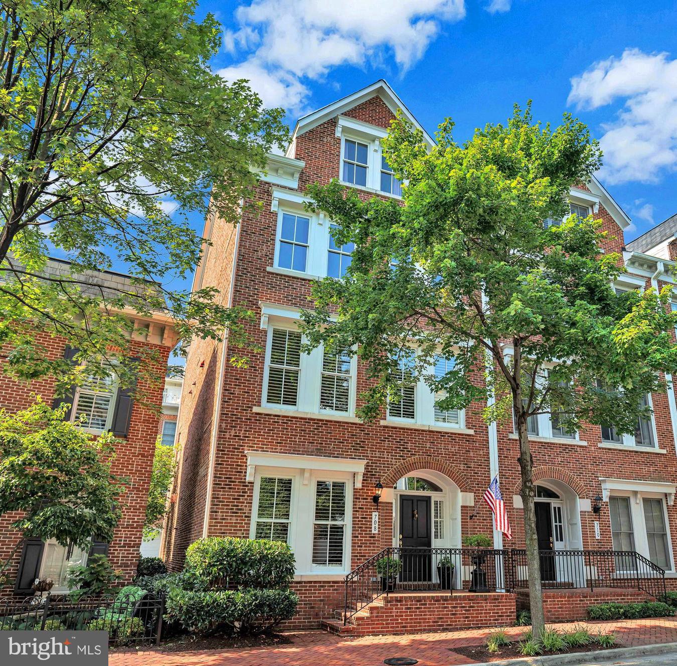 Boasting over $76,000 in thoughtful upgrades and offering over 3,700 square feet of refined living space, this exquisite all brick end unit townhome is flooded with natural light from windows on three sides. A gracious open foyer sets the tone, featuring diagonally laid tile flooring and a spacious double-door hall closet. Rich hardwood floors span the entry and main levels, enhancing the home’s elegant flow.
The entry level hosts a generous recreation room anchored by a gas fireplace with a striking stone accent wall, an inviting space for relaxation or casual gatherings. A convenient powder room and direct access to the oversized two car garage complete this level.
The main level is ideal for both entertaining and everyday living. The open-concept design is enhanced by expansive sightlines, oversized windows adorned with timeless plantation shutters, and ample recessed lighting. The formal living room is appointed with picture frame molding, while the dining room exudes classic sophistication with wainscoting and a graceful chandelier. The gourmet kitchen opens to a charming breakfast area and is outfitted with a large island and breakfast bar, granite countertops, stainless steel appliances, and a 2025 GE double oven. A surface cooktop with four plates and two grilling surfaces, under and overmount cabinet lighting, and plentiful cabinetry cater to any culinary enthusiast. A second powder room with a pedestal sink adds convenience on this level.
Ascending to the third floor, you’ll find the serene owner’s suite, complete with two custom walk-in closets, ceiling speakers, recessed lighting, Hunter Douglas Top/Down Bottom-Up shades, designer wall-to-wall carpeting, and a luxurious en-suite bath. The spa-inspired bath features a separate water closet, soaking tub, and a walk-in shower with a built-in bench. Two additional well-proportioned bedrooms, a full bath with a glass-paneled shower/tub combination, and a linen closet offer functionality and comfort. A full-sized laundry room with a 2018 washer and dryer is also located on this level for added convenience.
The top floor features an expansive loft, perfect as a secondary living area, media space, or guest retreat. It includes a wet bar with custom cabinetry, undermount lighting, a wine rack, and a spacious closet. From here, step out onto the private rooftop terrace with a newly installed handrail (2025), ideal for enjoying morning coffee, relaxing, or entertaining. Additional storage can be found in the utility closet behind the eaves perfect for luggage or seasonal décor. The attic includes flooring and lighting for even more accessible storage options.
Completing the top level is a private fourth bedroom with its own en-suite bath and cozy sitting area, perfect for guests or multi-generational living.
The oversized garage includes custom built-in cabinetry, a tool bench, an overhead storage rack, a full-size refrigerator, and freshly coated Floortek Polyaspartic flooring, offering both functionality and a polished finish. This wonderful home is located in the desirable Potomac Greens community, where residents enjoy access to a stately clubhouse with meeting and party rooms, a fitness center, an outdoor heated pool, landscaped pocket parks, tot lots, scenic nature trails, and Capital Bike Share stations. The community is just moments from the new Potomac Yard Metro, Amazon HQ2, Virginia Tech’s Innovation Campus, and the shops and restaurants of Old Town Alexandria and Del Ray. With easy access to the George Washington Parkway, Mount Vernon bike trail, and major commuter routes including I-495, I-395, and I-95, and just two traffic lights to downtown D.C. and Reagan National Airport, this home combines elegance, lifestyle, and convenience in one exceptional offering.
For a full list of features and detailed floor plans, please refer to the Documents section.
**Amazing 2.25% assumable mortgage for a qualified VA buyer with their own