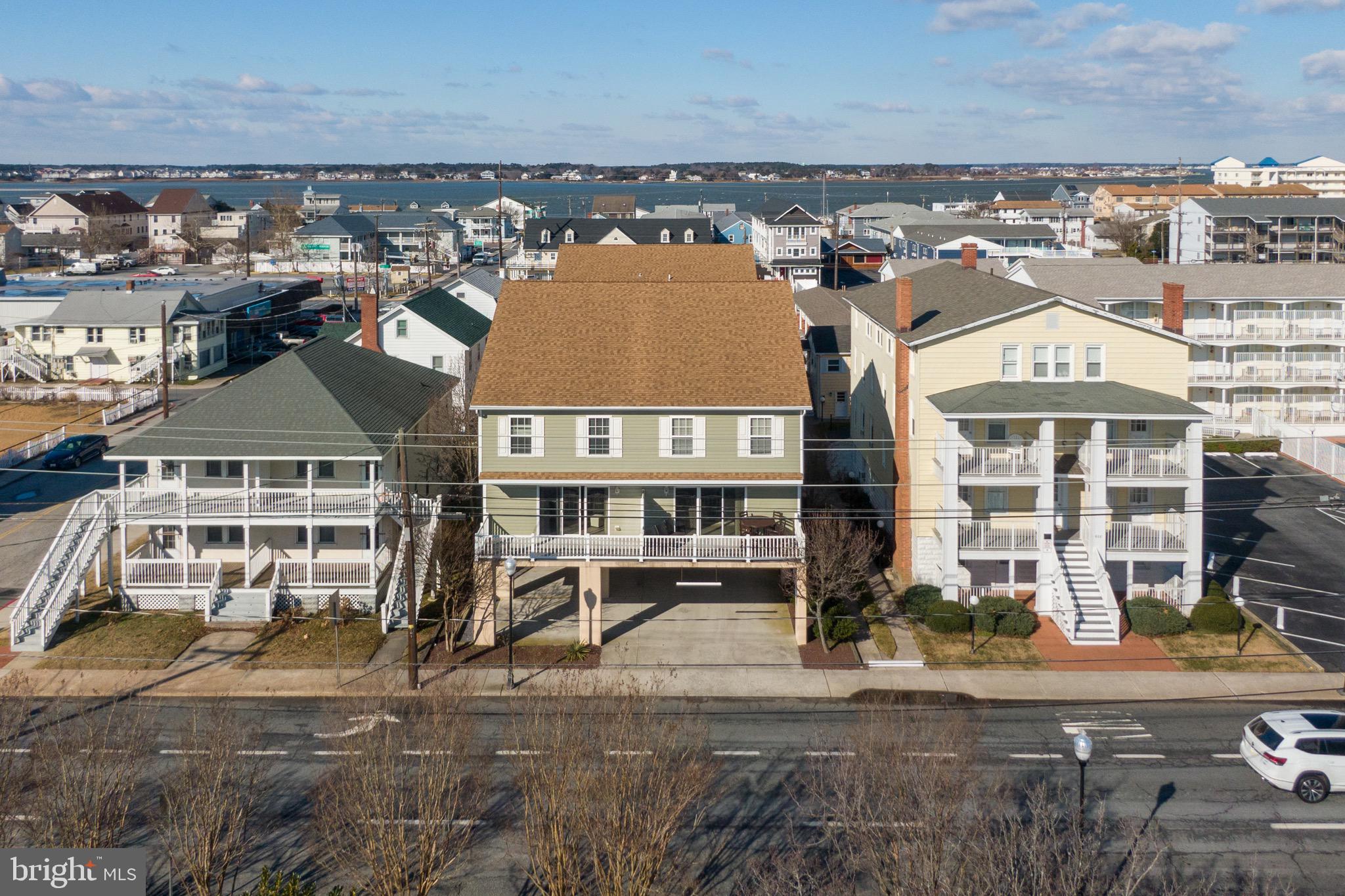This spacious and modern 3 bed 3 bath unit is a 2006 Build, and currently renting weekly with 2025 Rentals that must be honored on the books, yet helps pay for your mortgage. Enjoy the convenient location of 8th St, just one block to the famous Ocean City Boardwalk and beach. Perfect for larger groups as these units sleep up to 15 guests for an income producing unit from the day you purchase it. Better yet is that this unit is available with or without the adjoining unit. Purchase one or Both for a 6 bed 6 bath mega property spanning over 3700 sq feet and become one of the few 6+ bedrooms properties. Currently part of a condo association, but combined is the entire front building including 5 combined parking spaces that are covered