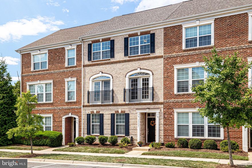 Welcome home to 19461 Xerox Drive!  Located in the awesome Lansdowne Town Center neighborhood, this brick-front townhome offers great space in a convenient and fun location! The entrance level greets you with a large foyer, which opens through double doors to a main level office, which could also be used as an additional bedroom. This room has two closets and a connecting powder room.  The two-car garage is also accessible from this level.  Hardwood stairs lead to the main living level. The main living level has beautiful hardwood floors throughout!  The living room has two sets of glass French doors with transom windows above providing great natural light.  There is also a ceiling fan and crown mouldings in the living room. The dining room has chair rail and crown mouldings as well as "shadow-box" mouldings.  The dining room opens to the table-space kitchen which is loaded with great features!  The kitchen has beautiful hardwoods, granite counters with ceramic tiled backsplash, and a large center island with room for casual dining.  The kitchen has stainless steel appliances (refrigerator, dishwasher and built-in microwave are all new - 2021).  There are 42-inch cabinets as well as a pantry closet for ample storage. The table-space area also offers great casual dining and has views of the main deck through two large windows and access through the glass French door.  The upper level has three bedrooms and two full bathrooms.  The laundry closet is also on the upper level.  The primary suite features a tray ceiling with a ceiling fan, a wall of windows and a glass French door to the balcony, and two closets with built-ins!  The primary bathroom has a soaking tub and a separate ceramic tiled shower, ceramic tiled floors, double vanity sinks, and a water closet. There are two additional bedrooms on this level, and both offer large closet space, ceiling fans and neutral carpet.  There is also a full hall bathroom with a ceramic tiled shower/tub, ceramic tiled floors and double vanity sinks.  The laundry closet features new, full-sized washer and dryer - 2021.  NEW ROOF: August, 2022.  LOCATION: The Lansdowne Town Center offers great amenities for you to enjoy!  Easy stroll to nice restaurants, coffee shops, shopping, and more!  Harris Teeter and CVS are also close by!  The neighborhood has sidewalks and walking paths, the golf course is steps from the home, dog park areas, tot lot spaces and play areas, and the clubhouse/health club and pool.  Minutes from One Loudoun and Downtown Leesburg. Close to major commuter routes including Route 7, Route 28, and the Dulles Greenway.
