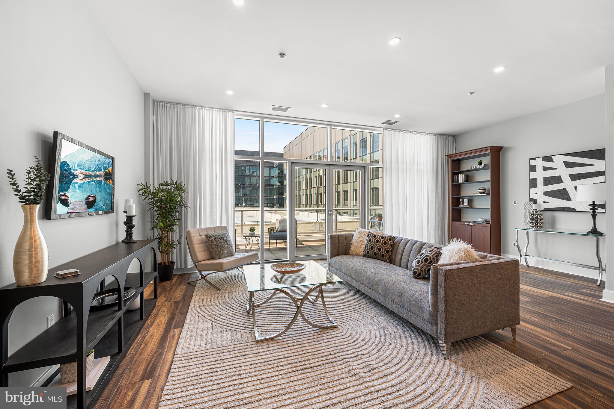 This comfortable and accessible two-story penthouse redefines the concept of home with an open floor plan, floor-to-ceiling windows, and THREE private balconies. The high ceilings and overall width highlight the scale of this home; you'll feel it the moment you walk in the door. The large kitchen features ample marble counter space and cabinet storage, a customized pantry, an upgraded backsplash, and a breakfast bar, all overlooking an enormous living and dining area with new flooring. The first floor, with upgraded touches, ample natural light, and a refinished powder room, also features an alcove that can be arranged as a working den or extra seating area. A wide staircase leads up to two magnificently large bedrooms, each with its private marble bath, floor-to-ceiling windows, significant closet space, and a private balcony in each bedroom. The first bedroom boasts the highest ceiling height, a skylight, an extra-wide closet, a full bathroom, and a balcony. The hallway leading to the Master Bedroom offers a deep, shelved closet for linens and storage, as well as a wide laundry room with a side-by-side washer and dryer and extra shelving. The enormous master bedroom features two walk-in California closets with personalized finishes, an additional storage closet, and a spacious bathroom with a shower, a tub, and his-and-her cabinets. The Master Bedroom overlooks the inner terrace and the building's gardens, featuring a balcony that offers an oasis to those seeking a quiet, green space amidst city life. Both bedrooms have customized blackout curtains that block out light and noise, providing a peaceful evening experience. This penthouse condo features under-stairs storage and a storage unit located within the building. This elevator doorman building is minutes from Penn, Drexel, 30th Street Station, and Rittenhouse Square. Enjoy the beauty of the recently extended Schuylkill River Walkway. Within a few blocks, you'll find The Fitler Club, Trader Joe's, and Giant. A garage is located inside the building, offering spaces available for rent or for sale.