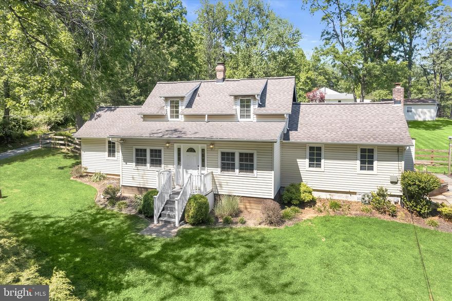 Spacious Cape Cod set on a premium .97-acre lot, offering privacy, charm, and thoughtful updates throughout. Improvements include new fencing, updated flooring, roof and siding (2005), septic pump line, and more. Enter through a versatile bonus room ideal as a sunroom or home office, opening to a bright, open-concept living and dining area. The home flows into a large family room with an en suite powder room and direct access to the expansive deck and backyard, perfect for everyday living and entertaining. The eat-in kitchen with breakfast area showcases a rustic exposed wood beam ceiling, adding warmth and character. A convenient entry-level primary bedroom suite features an attached full bath and walk-in closet. Upstairs, you’ll find two additional bedrooms and a full bathroom. The lower level offers endless potential and awaits your customization. Outdoors, enjoy the expansive deck overlooking the fenced, landscaped yard complete with a large storage shed equipped with electric and workbenches, ideal for hobbies or projects. Ideally located near major commuter routes, shopping, dining, and entertainment, this home combines space, comfort, and convenience in a picturesque setting.   (some photos have been virtually staged)