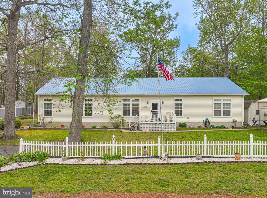 Tucked away on a quiet dead-end street, this charming single-level home offers the perfect blend of space, privacy, and functionality. Situated on a rare double lot, the property provides ample room to enjoy outdoor living, with half of the yard being fenced in ideal for pets, play, or future expansion.

Inside, you’ll find a thoughtfully designed open-concept layout featuring a spacious living room, dining area, and large kitchen with ample cabinet space—perfect for both everyday living and entertaining.  The home offers three comfortable bedrooms and two full bathrooms, along with a dedicated laundry room for added convenience. A cozy wood-burning fireplace anchors the bonus living space, which could also be used as a fourth bedroom.

The primary suite includes a private office just off the bedroom and bathroom, creating the ideal space for working from home, a nursery, or a quiet retreat.

Step outside to relax on the screened-in porch, where you can enjoy peaceful surroundings year-round. A durable metal roof, replaced in 2020, adds long-term value and peace of mind.

Whether you’re looking for a primary residence or a coastal retreat, this property offers quiet living with room to grow.