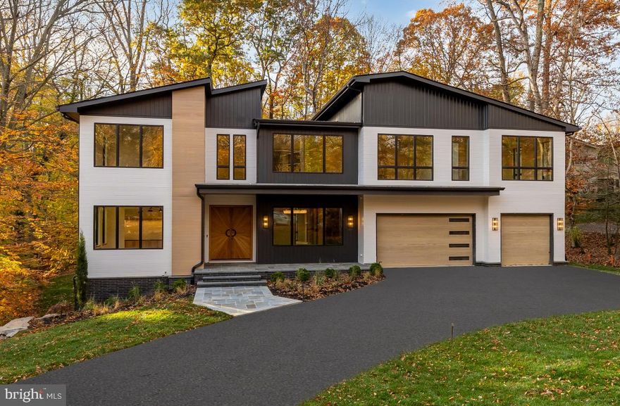 ***OPEN HOUSE SATURDAY Dec 13th from 1-3PM*** Framed by panoramic wooded views and backing to 25 acres of protected parkland, this newly constructed Mid-Century Modern masterpiece, built by Foxhall Homes and designed by ElieBen Architecture, balances sophisticated design with livability, featuring a private Savaria Eclipse elevator and seamless indoor-outdoor living.
 
The handcrafted Starburst double entry doors in flat-sawn white oak (locally made by Phirst and Lassing) defines the home’s signature aesthetic. Wide-plank white oak floors, rift-cut TruStile solid-core doors with Emtek hardware, and custom white oak millwork reinforce an organic modernist feel throughout.
 
The heart of the home is a chef’s kitchen anchored by a 10-foot Cristallo Iceberg Quartzite island surrounded by custom rift-sawn white oak cabinetry. The culinary engine is a showpiece custom matte-black and satin-brass BlueStar 48” Nova RNB range paired with paneled 48” Jenn-Air refrigerator. The fully equipped butlers pantry with integrated under shelf lighting, wine refrigerator and sink serves as a discreet service area for effortless hosting and organized storage.

Open living spaces are designed for presence and comfort. A sculptural ring chandelier with reeded glass panels floats above the gas fireplace.  The vaulted family room, clad in Modern Mill ceiling accents, features a curved wet bar and direct access to the full-width bluestone covered terrace overlooking the serene parkland.
 
The primary suite is a true sanctuary with expansive woodland views from the private balcony.  The spa-inspired bath offers radiant-heated terrazzo floors, curbless two-person shower with thermostatic controls, six-foot solid-surface tub with Kallista filler, and floating rift-sawn white oak vanities illuminated by alabaster sconces from Visual Comfort.
 
The daylight walk-out lower level impresses with nearly 10-foot ceilings, full-height windows, a wraparound bar, custom home gym, and premium finishes—ideal for media, entertaining, or overnight guests.  
Beyond stunning aesthetics, this home is engineered to last, exceeding building standards with superior materials: Huber ZIP System sheathing, Advantech subflooring, and Andersen 400 Series casement windows. The low-maintenance exterior combines Hardie Artisan and Modern Mill Acre composite siding with elegant Watsontown brick accents—built to look flawless for decades.
Smart & Efficient Systems include:
 
● 5-zone in-ceiling Sonos with VSSL amplification and AirPlay 
● Dual-zone Carrier high-efficiency HVAC with ecobee thermostats
● Prewired for full security suite and hard-wired mesh network
● EV-ready garage with R-18 insulated high-lift door
 
Timeless Mid-Century design meets uncompromising craftsmanship in an unbeatable private setting. Schedule your private tour and experience the distinct character firsthand.