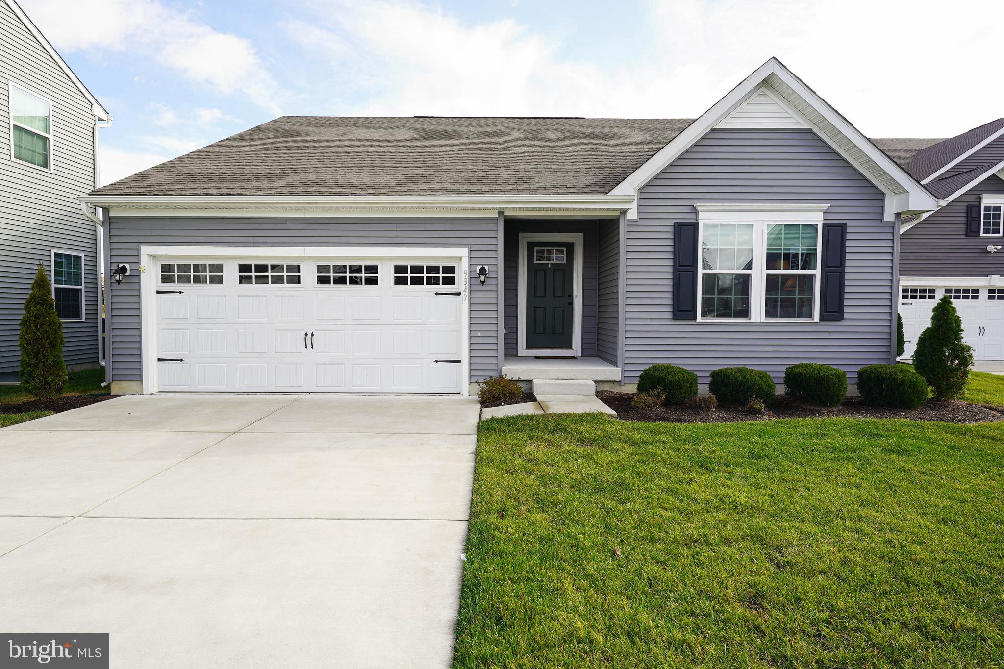 Welcome to this meticulously maintained 3-bedroom, 2-bath home in the highly sought-after Wood Creek Community in Delmar, Maryland. Thoughtfully designed and built in 2022, this home offers a perfect blend of comfort, style, and accessibility—ideal for anyone seeking peace of mind and low-maintenance living. Step inside to enjoy a bright, open-concept layout with luxury vinyl plank (LVP) flooring throughout. The heart of the home is a stunning kitchen featuring quartz countertops, an 18-inch tile backsplash, stainless steel appliances, pendulum lighting, and a large integrated sink—perfect for both everyday living and entertaining. The home includes three spacious bedrooms, providing flexibility for guests, hobbies, or home office needs. The primary suite offers a serene retreat with a beautifully tiled en-suite bath, featuring a glass-enclosed shower, handicap-accessible rails, and a double vanity for added space and convenience. A second tiled bathroom adds comfort and privacy for family and guests. Accessibility is built in, with a handicap ramp system in the garage, ensuring safe and easy entry. Outdoor living is just as inviting, thanks to a 12x24 composite rear deck with vinyl handrails which provides wide-open, unobstructed views of plush greenery and nearby pond and is the perfect spot to enjoy your morning coffee or a relaxing evening with family or friends. Additional features include a lawn sprinkler system, a meticulously kept exterior, and a quiet, welcoming neighborhood setting. Located just minutes from local dining, shopping, and healthcare, this home makes it easy to enjoy life on your terms. Don't miss this opportunity to own a move-in-ready home in a premier community. Schedule your private tour today!