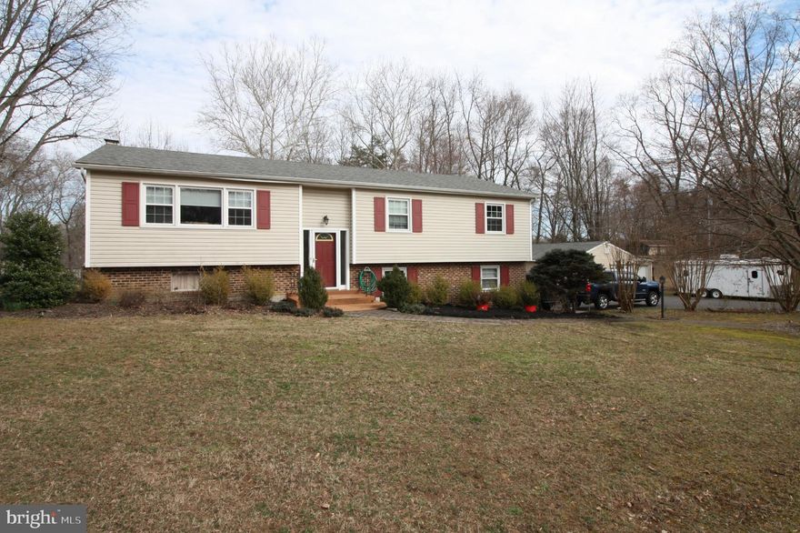 BRING YOUR BIGGEST GRILL !!!Looking for peace and quiet??? Here it is !!Almost 2 full usable acres to call your own private retreat. Relax on the 2 tiered deck after a long day at work. Home has been remodeled thruout and the wow factor is there. Large open kitchen/dining/living area with granite counter and breakfast bar that will accomodate 5-6 stools. All Stainless appliance and beautiful hardwood make this the focal area of the house !!. Three good size bedrooms on main level with a  4th on lower level. There is also a Pellet stove on lower level that will keep the whole house warm ! The 3 baths have all been upgraded and the master bath enlarged. There is no HOA to contend with so you can do whatever you wish !!These type properties don't come around often, so don't snooze!! Call today to see it!