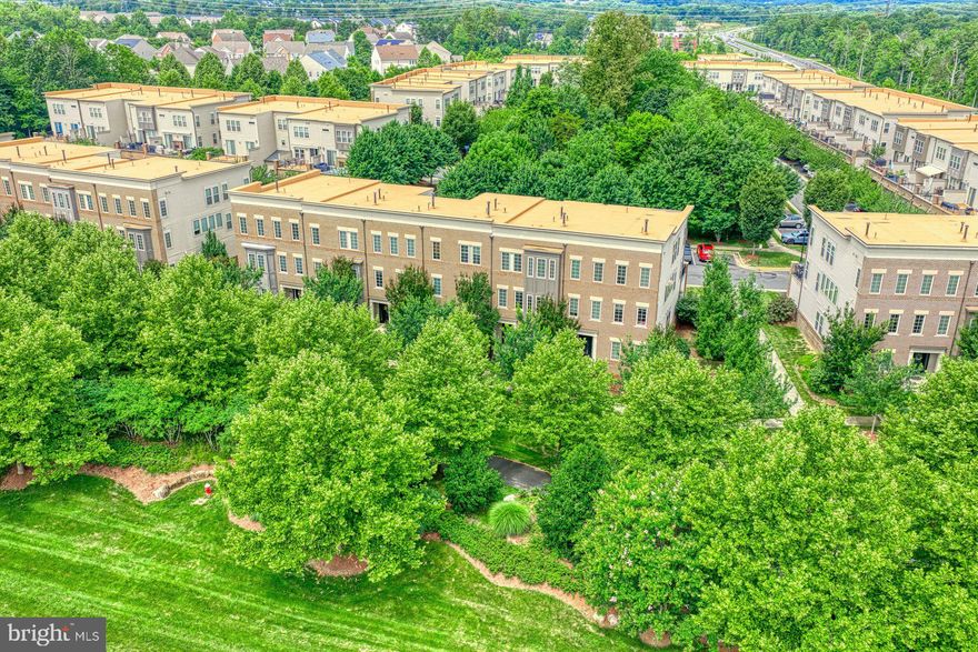 Welcome home to this beautiful Miller & Smith built three level townhome near Brambleton Town Center with fresh carpet & fresh paint! The open concept main level living space features upgraded flooring. Large kitchen with white cabinetry, stainless steel appliances & large island. Dining room with wall of windows & upgraded chandelier. Spacious living room with gas fireplace & access to the rear outdoor entertaining space overlooking wooded common area.  Upper level primary suite with tons of closet space & luxurious bath with soaking tub, separate shower & dual vanities. Two additional spacious bedrooms, full bath & laundry room with full size washer & dryer complete the upper level. The lower level features large recreation room, 4th bedroom/den, 3rd full  bath & access to the oversized two car garage. Upgrades & updates throughout including installing new soffits/panels/trim boards & molding on box bay structures on front & rear of home with Hardie paneling/trim (2024), outside HVAC unit replaced (2024), dishwasher (2023), washing machine (2023), hot water heater (2022), refrigerator (2019) & more! This home is located in the amenity rich Brambleton community & a is a short distance to Brambleton Town Center.  Nearby schools, commuter routes, shopping, dining & parks too!