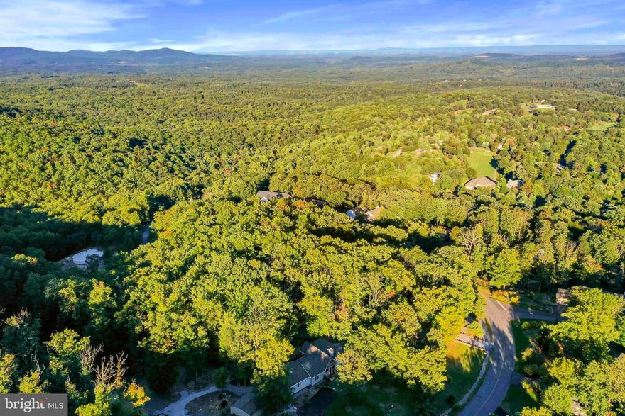 Beautiful 0.6891 wooded acre homesite located on Toboggan Hill Trail with breathtaking winter mountain views! Build your dream vacation or primary/retirement home at The Woods with underground utilities, public water and public sewer. Come walk the property to see this great location! Class A membership is available with an initiation fee of $3,150.00.