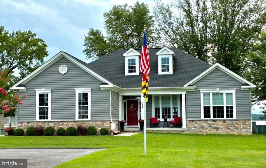 OWNER HAS FOUND HOME OF CHOICE AND IS LOOKING TO SELL this Impeccably Maintained Compliments the Pride of Ownership on this Custom Built in 2020 Waterfront Rancher with Expansive Waterfront Views. This home is literally brand new as it has been very lightly lived in. The owner left no stone unturned with the design, upgrades and amenities. The Quality starts as you enter the large fenced property with large parking area leading to the covered front porch. As you enter the home the open foyer welcomes you with it's wide entry & hardwood floors leading to the wide open floor plan to include the Impressive Kitchen with Massive 5x10 Quartz Island with Seating, 42" Soft Close Cabinets, Quartz Counters, Stainless Steel Appliances, Deep Well Sink, Wine Fridge and table seating with water views!! The Family Room off the the kitchen is accented with it's stone fireplace. The main living area offers hardwood floors and cathedral ceilings. Another great feature is the office with glass door accents. The primary suite is huge to include the exquisite primary bath with double vanity, jetted corner tub and large tiled shower with bench seat. The 2nd & 3rd bedroom are good size and share the 2nd full bath. There is added convenience to also have a 1/2 bath off the family room and 1st floor mud/laundry room. The full basement is massive in size with a 3 piece rough in and offers 9 ft ceilings and walk up stairs to the back yard. The lower level is wide open and offers an additional 1,942 square ft to be finished - totaling 3,928 square ft that this home has to offer!! An added bonus is the finished screen porch overlooking the large yard with river views. The yard is flat and elevated with endless water views that lead to the long  76 ft pier with 10x18 platform and multiple mooring poles. The home is centrally located and EZ access to major highways. This home is a beautiful waterfront minutes to the Bay and awaiting your arrival to Enjoy Waterfront Living for many years to come!!