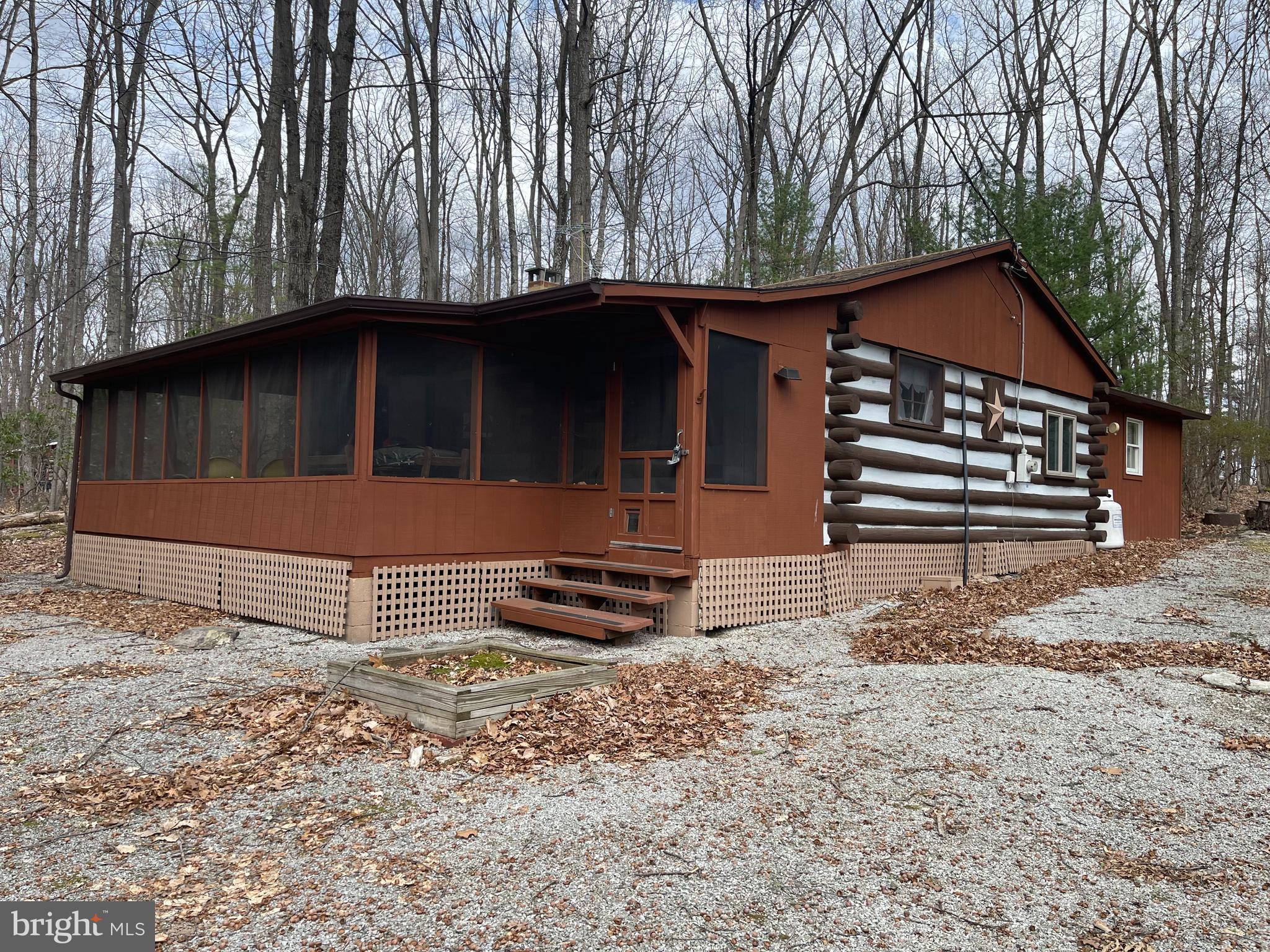 LOCK, STOCK, & BARRELL! Secluded Cabin home with 2 bedrooms and 2 full baths. All remaining furniture, appliances, outdoor furniture, hot tub (as-is), and home goods included so you will be ready to use this summer or winter retreat. Lake is for owner use only. Seller used seasonally only, buy for your summer get-a-way or winter retreat. Don't delay seeing this home. Located in Orrtanna, PA off the beaten path.