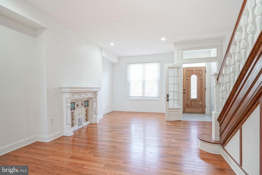 Welcome to 2138 Morris St — a thoughtfully renovated home that blends the original character of South Philly with a clean, modern design. Details that cannot be replicated are still here — a vestibule entry with French doors, original archways with fluted columns, a restored staircase with turned spindles and a decorative tile fireplace that anchors the living room. Elements that define the home and set it apart from recent renovations that have removed them. The main level features beautiful hardwood floors, recessed lighting and a fully remodeled kitchen with granite countertops, stainless steel appliances and a tile backsplash. A half bath was added to the main level for added convenience, and a brand new washer and dryer will be in place prior to showings. The basement offers room for expansion with a walk-up exterior entrance for extra functionality. The private rear patio offers outdoor space in the heart of the city. For homebuyers and investors alike, Morris Street is a prime location, situated just off Point Breeze Avenue with easy access to local favorites, transportation and new construction all around. Seller is including a 1-YR AHS Home Warranty.  Don't wait — schedule your tour today and make 2138 Morris Street your new home. Be sure to visit the virtual tour.