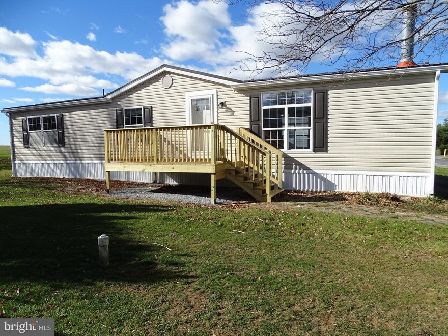 Let the fireplace be the focal point of your home from your kitchen, dining or living room. Beautifully renovated 28x 56 multi section home offers a  3 bedroom and 2 bath home ready to move into. Upgrades to the home include new metal roof on the home and shed, new decks, complete new bathrooms, carpet and vinyl, flooring, skirting, insulation, plumbing and lighting fixtures and new heat pump. Do not miss this one. 
Community has a pet policy of 1 dog of a non aggressive breed and 1 indoor cat or 2 indoor cats, no fences.
