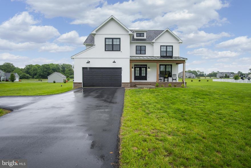 Welcome home to the perfect mix of fresh, modern design and laid-back country charm. Set on 1.4 acres in the exclusive Little Georgetown Estates, this like-new 5 bedroom, 2.5 bath modern farmhouse has everything you’ve been dreaming of-and more. From the moment you step onto the inviting full front porch, you’ll feel the warmth and personality this home offers. Inside, the main level is wide open and full of light, with gorgeous hardwood floors, custom built-ins, and stylish touches like wooden ceiling beams and a gas fireplace that anchors the cozy family room. The chef’s kitchen is made for real life and real entertaining, with an oversized island, gas cooking, tons of cabinet & counter space, and a walk-in pantry. The family room, dining & kitchen flow effortlessly from one space into the next. Need a quiet space to work from home or host guests? You’ll love the main-level bedroom or home office, privately tucked away behind a rustic sliding barn door. There is also a convenient mud room just off the garage with a built in bench and coat station. Upstairs, the spacious primary suite offers a relaxing escape with a tray ceiling, a huge walk-in closet, and a spa-like bath featuring dual vanities, a freestanding soaking tub, and a walk-in shower. There’s also a loft area that works great as a playroom, homework space, or bonus lounge—and the secondary bedrooms are all generously sized, giving everyone room to spread out. The laundry room is conveniently located on the bedroom level as well. There’s also a full unfinished basement with rough-in for a future bathroom—ready when you are to finish it your way. Outside you will love the large covered rear porch—ideal for weekend barbecues, morning coffee, or just unwinding. Located in the Spring Mills school district, this home is packed with quality finishes, thoughtful details, and room to grow.