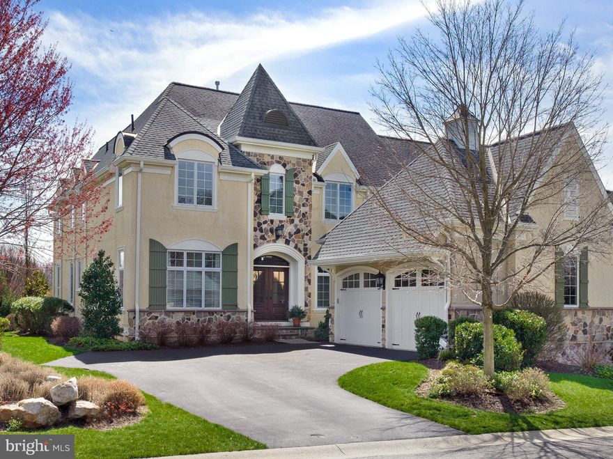 Award-winning Haverford Reserve affords a luxurious maintenance-free lifestyle in the heart of the Main Line. Here impeccably-crafted residences border a magnificent landscape of 124 acres of preserved woodland, with rolling hills, peaceful streams, walking and nature trails, and 45 acres of recreational areas to enjoy! This exquisite Pembrey model set on a premium private lot with scenic views is finely appointed and generously-sized for your family. Interiors are enriched by 9’ ceilings, oak wood floors, tasteful moldings & wainscoting, and upscale finishes throughout. Outdoor pleasure is had on the fabulous rear deck and enormous patio for summer barbecues, cocktail parties, or simply lounging with the paper while taking in the views. Kids and pets can play nearby on the lovely lawn area. This 4 bedroom, 4.1 bath beauty greets you with a gracious light-filled foyer with arched openings on both sides. At left is the elegant living room, and at right is the formal dining room providing a seamless flow for entertaining. A butlers pantry sits nearby with cherry cabinets, granite counters, and a wine fridge for easy serving. The chef will love creating meals in the spacious gourmet kitchen as the family gathers round the island or dines in the sunny breakfast room. Cooks quarters are appointed with floor-to-ceiling cabinetry, granite counters, and high-end stainless steel appliances. Open from there is the inviting vaulted family room with a soaring beamed ceiling, wood-burning fireplace, and built-in entertainment center for TV, movie and sports nights. Glass-paneled doors open to the deck and paver stone patio oasis for effortless indoor-outdoor living/hosting. An office with handsome cherry built-ins, mudroom with wall of windows, guest powder room, and 2-car garage access complete the main level. Upper level sleeping quarters present 3 well-proportioned bedroom suites. The expansive owners retreat offers his & her walk-in wardrobe closets, and a lavish primary bathroom with dual vanities, marble floors, soaking tub and oversized spa shower. An added bonus room with French glass doors is a perfect home office, sewing/crafts room, playroom, etc.; plus there is laundry and abundant closets on the 2nd level. The finished lower level has a comfortable family area, adjoining sitting/game room, bedroom and full bath. This wonderful home is also prepped for an elevator, has built-in speakers in the living room, kitchen and family room, and sits in a coveted location near the Main Lines best offerings.