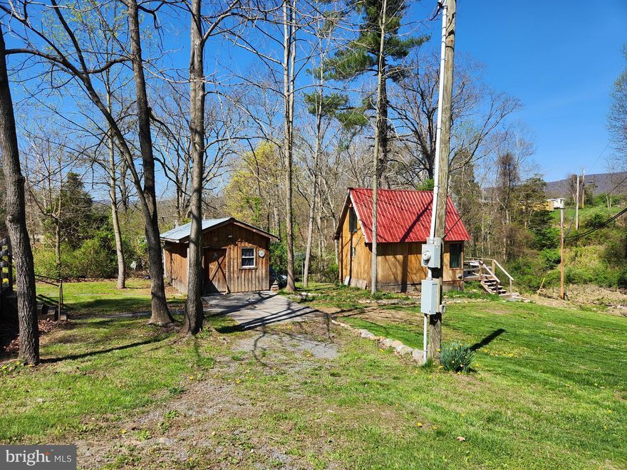 One of a Kind!
Your own creek, little waterfalls and a private deer blind come with this 1.15 acres.  Tiny home has ample kitchen with quartz countertop and breakfast bar. Farm sink, full sized fridge, and cooktop offer perfect set up.  Loft is the coziest bedroom with sitting area, the full bath has tiled shower and room for towels and toiletries storage, plus a window for natural light.  Deck faces the creek and the firepit area. Enjoy cookouts, yard sports and star gazing at night. Large extra building for storage of tools, outdoor and River toys. Also used as a workshop with electric, concrete floor, shelving and place for a woodstove to stay warm doing winter time projects.   Spacious yard allows for multiple camp sites with power hook up for campers.  Enjoy being in the mountains and near the rivers, having peace, serenity and nature all around.