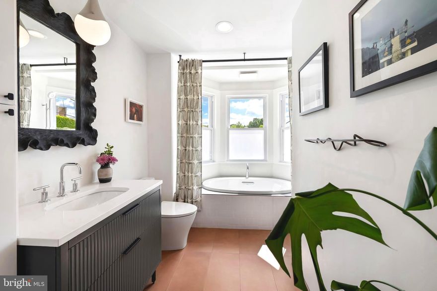 Set on a tree-lined street just one block from Wyman Park, this 1901 rowhouse marries design magazine–worthy style with Hampden soul. From 2019 to 2024, the home’s devoted stewards took on a slow and intentional renovation—living in the space, mapping how natural light moved through each room, and letting the architecture guide their choices. With their own hands and a deep respect for the home’s history, they elevated every inch while honoring its original bones.  Thoughtfully reimagined to meet modern-day needs, they made the most of the home’s footprint—creating a space that feels tailored, timeless, and rarity in today’s market.

Beyond the classic Baltimore porch—complete with a little front-yard Free Little Library crafted from a reclaimed newspaper stand—the main level flows from an electric fireplace–anchored living room to a dining room. A sleek galley kitchen features honed, easy-to-maintain soapstone counters, a large sink, smart storage, and open shelving. A powder room and laundry closet are tucked neatly out of sight for everyday ease.

Upstairs, a light-filled bedroom sits across the hall from a separate built-in workstation room—ideal as a remote office or cozy reading nook. The showstopper: a bathroom designed by local designer Kelsey McNerney of By Noone Studio, with a spa-like tub perfectly positioned under three windows to capture natural light. The top floor adds another bright bedroom and a versatile bonus room currently used as a walk-in closet but easily transformed into a third bedroom or work space. Connected to the third room is a second full bath, anchored by a stunning marble sink, generous storage, and a large, loft-style shower.

Fresh white paint, modern light fixtures, and lightly rebrushed original floors layer texture and brightness throughout, while an unfinished basement awaits your storage needs.

Step outside to a generous deck that flows onto a stone patio—perfect for al fresco dinners under café lights—while a multi-purpose shed keeps bikes, tools, and gear tucked away. A private parking pad takes the hassle out of city parking. Here you will be close to nearby restaurants, boutiques, parks, and the vibrant energy of “The Ave,” and just down the road from  I‑83. This home is a rare blend of heart, style, and location—ready for its next chapter with a new steward. OFFER DEADLINE - TUESDAY, MAY 13th at 10AM.