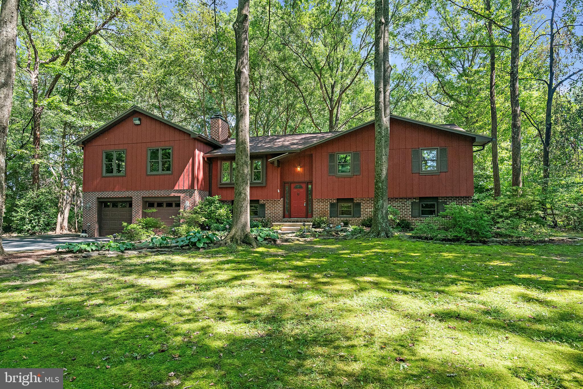 Welcome to this stunning, tree-shaded property situated on a 2.06-acre wooded lot, offering privacy, tranquility, and space to enjoy both inside and out. This home has been thoughtfully upgraded, including a new primary suite, sunroom, and an attached two-car garage, making it as functional as it is beautiful.
The original primary suite and three additional bedrooms provide plenty of options for family and guests, complemented by a total of four full baths for convenience. The finished lower level expands your living space with a warm and inviting family room featuring a fireplace with wood stove, plus two versatile bonus rooms perfect for a home office, gym, or art studio. Step outside to your private outdoor oasis with two ponds, stream that appears to connect them, a large deck, and a brick patio—ideal for entertaining, gardening, or simply relaxing while enjoying the natural surroundings. This rare property combines spacious indoor living with unmatched outdoor amenities, creating a perfect balance of comfort, beauty, and functionality.