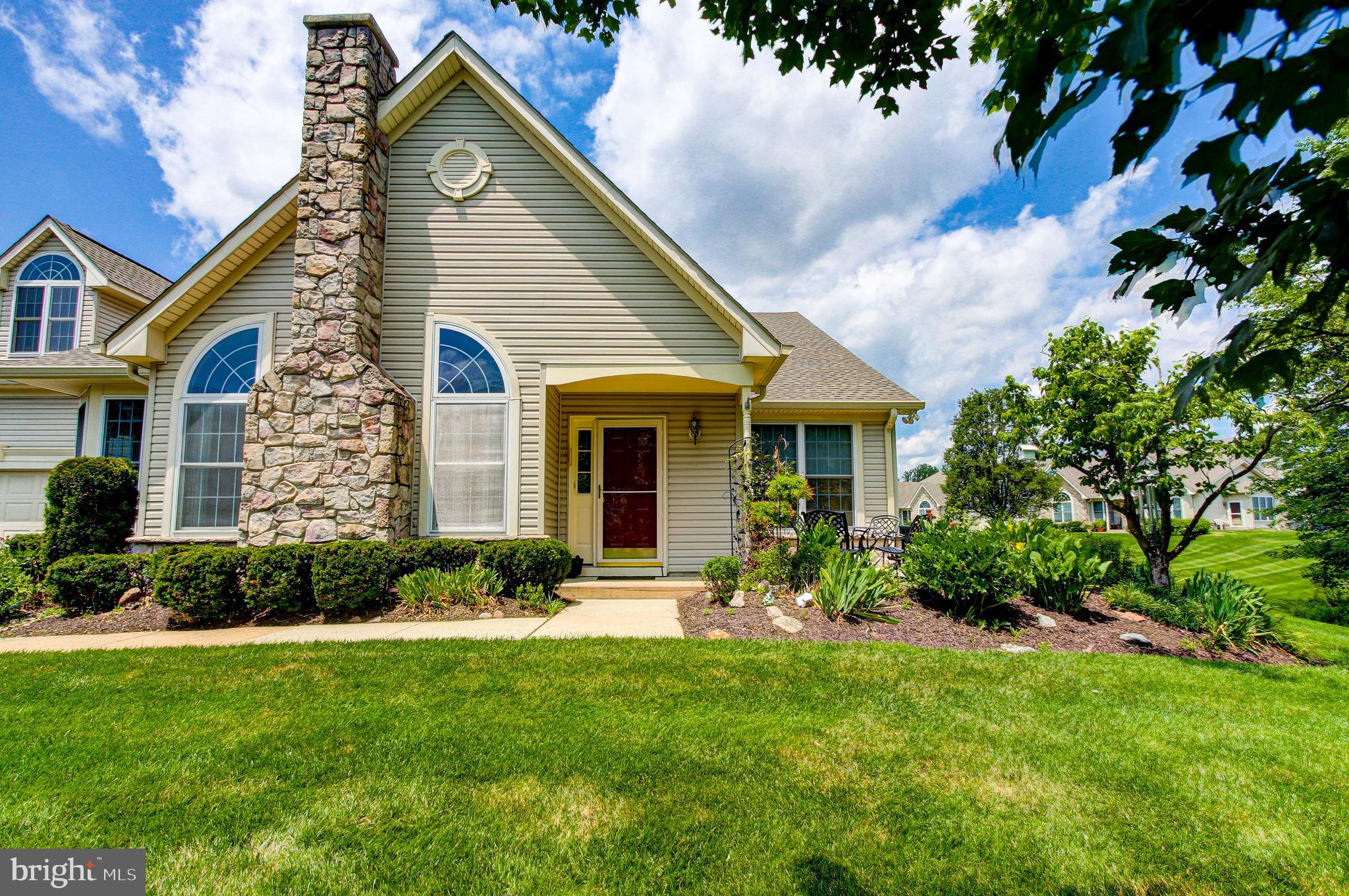 Welcome to this beautifully maintained end-unit Villa in the sought-after 55+ community - Villages of Flowers Mill. This spacious Mulberry model features a bright, open-concept family and dining room—perfect for entertaining or relaxing with guests. The eat-in kitchen offers plenty of space for casual meals and morning coffee. The main floor includes a generous primary bedroom suite with a private bath, along with a second bedroom and full hall bath for guests or hobbies. Upstairs, you'll find a private third bedroom or office with its own full bath—ideal for visitors or quiet workspace. Enjoy the nicely landscaped outdoor patio, perfect for morning breakfast or an afternoon glass of wine. New carpets, new paint and roof replaced in 2022. Located in a vibrant, amenity-rich community providing indoor pool, outdoor pool, tennis, pickle ball, bocce, clubhouse, ballroom, gym, library, billiards, exercise room, craft room & more!